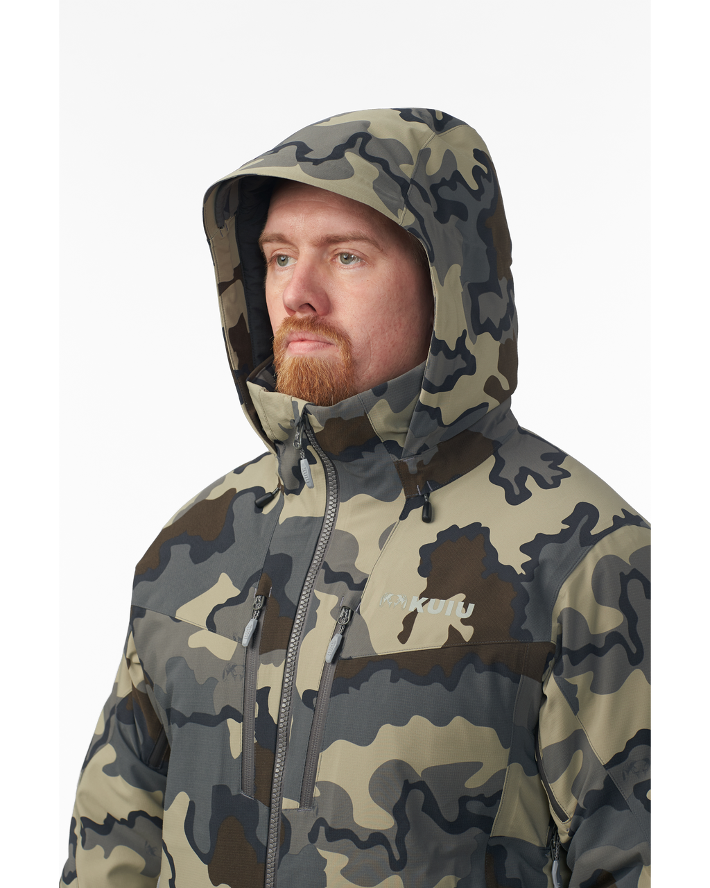 Hunter wearing helmet and hood on the Kutana Gale Force Hooded Jacket in Vias Camouflage