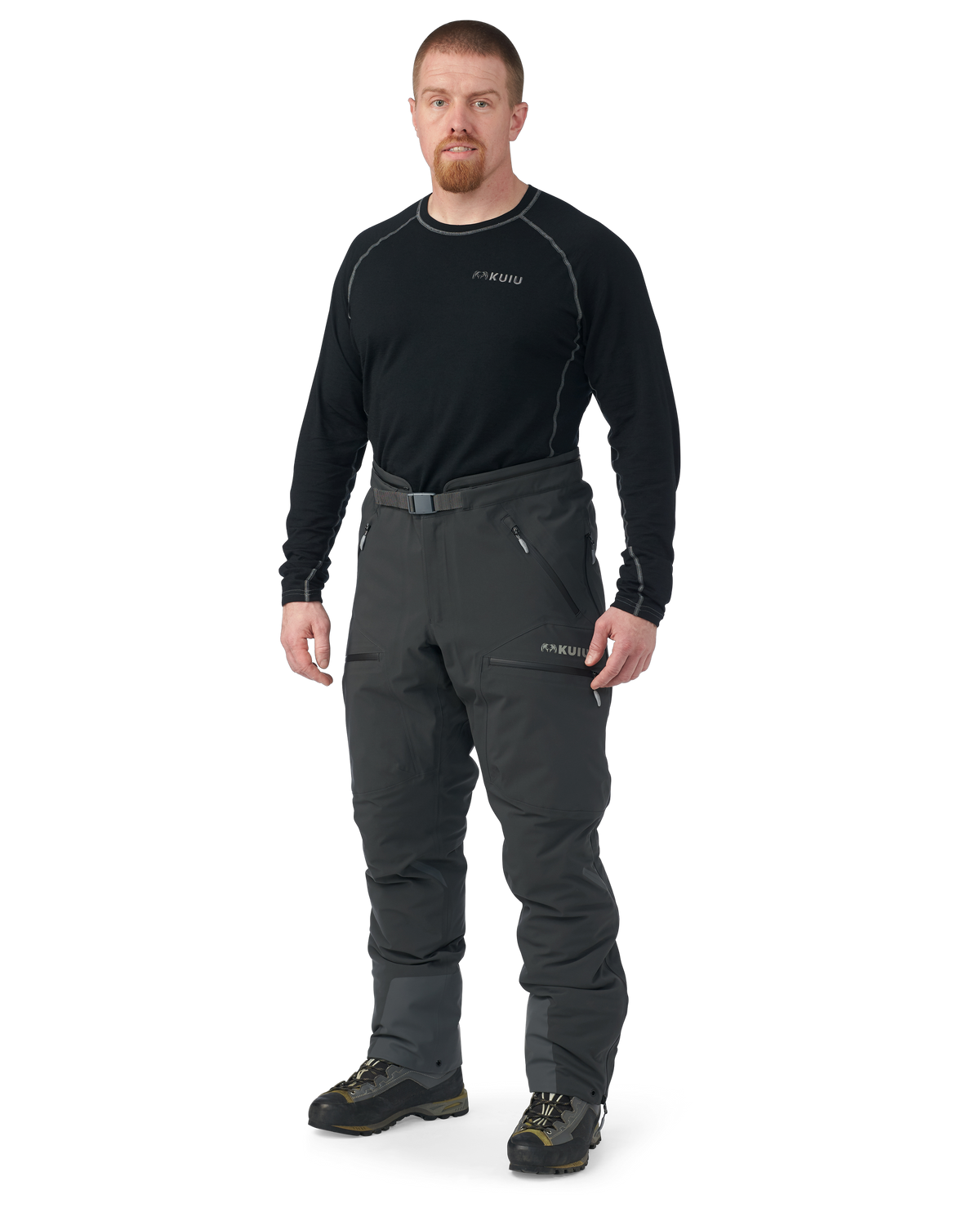 Hunter wearing Kutana Gale Force Pant in Gunmetal without suspenders over shoulders