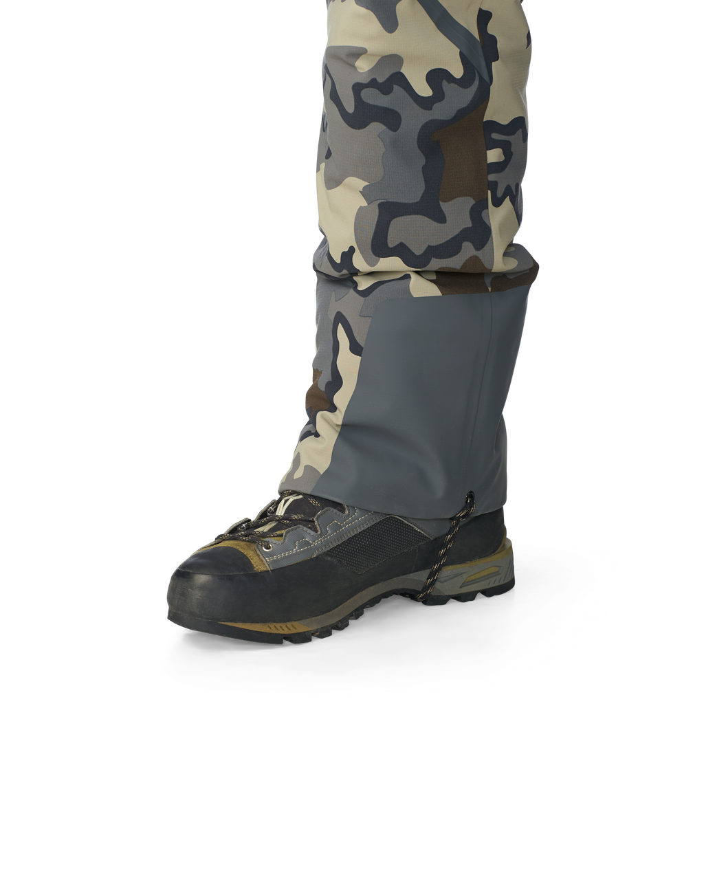 Hunter wearing Kutana Gale Force Pant in Vias Camouflage showcasing bottom ankle grommet