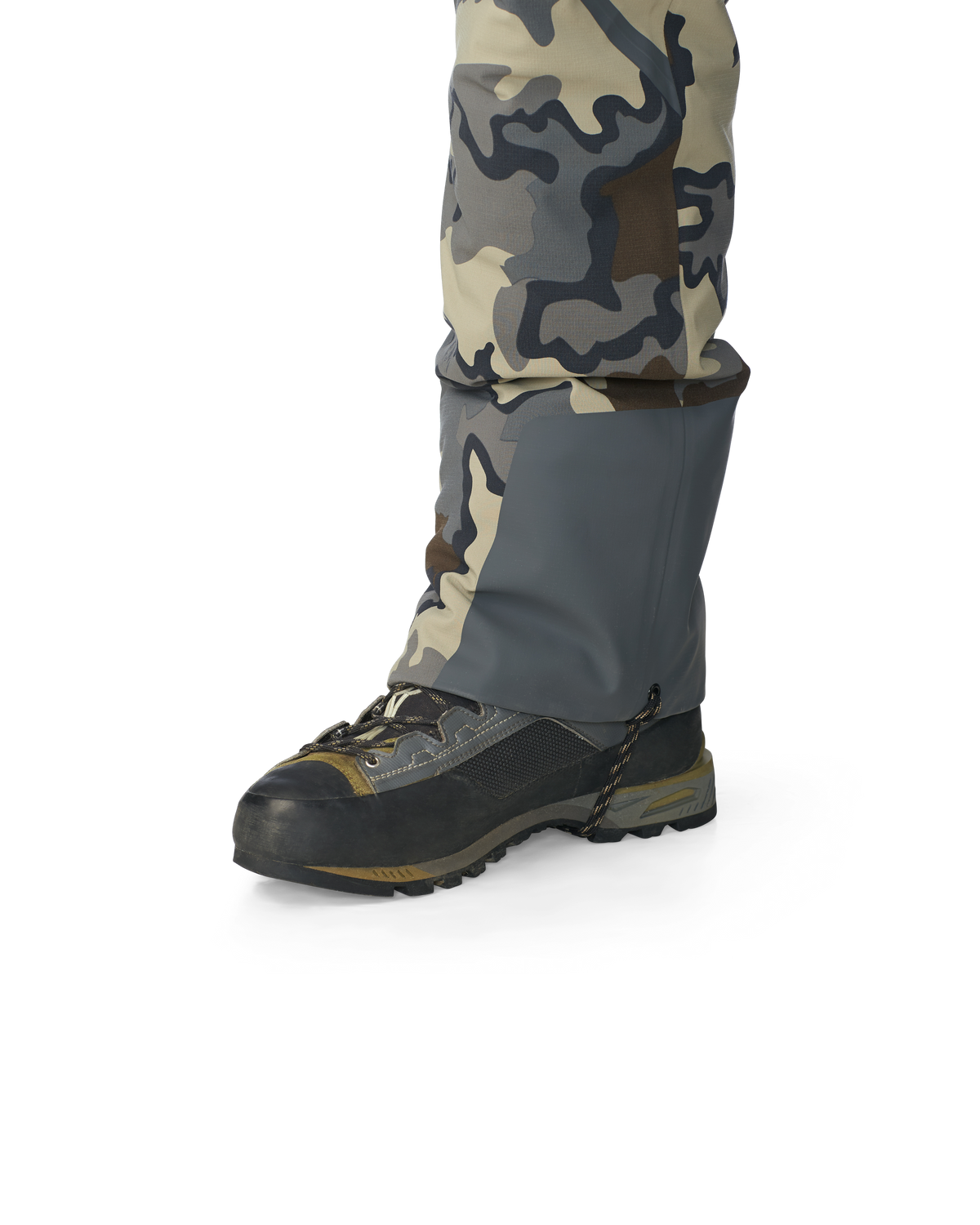 Hunter wearing Kutana Gale Force Pant in Vias Camouflage showcasing bottom ankle grommet