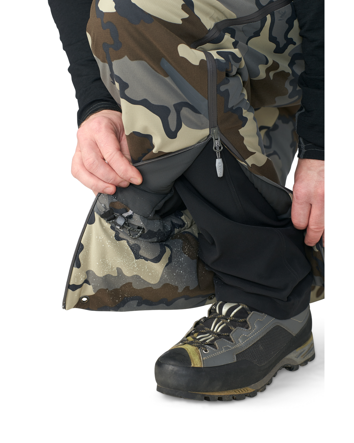 Hunter wearing Kutana Gale Force Pant in Vias Camouflage showcasing inner ankle fabric