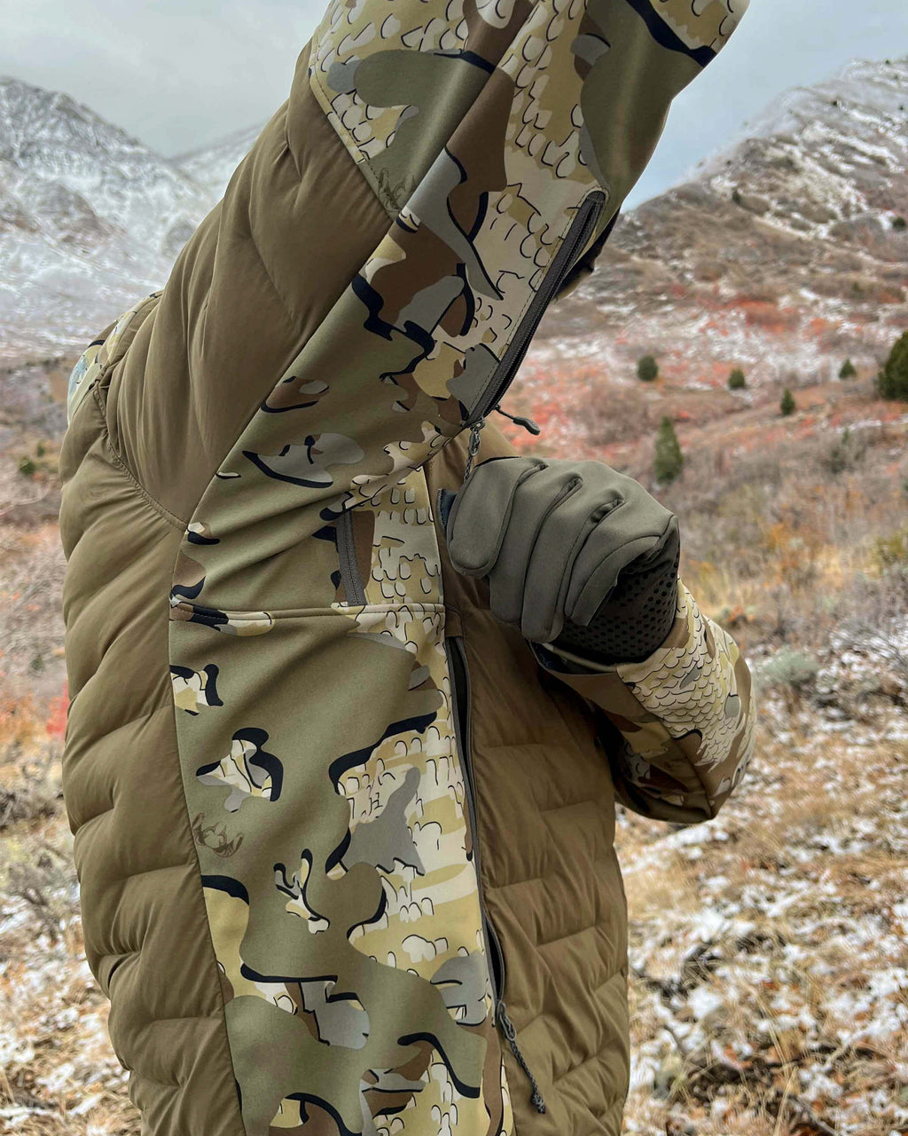 Side of Hunter Wearing Axis Thermal Hybrid Hooded Jacket in Valo Camouflage Highlighting YKK Zippered Pit Vents
