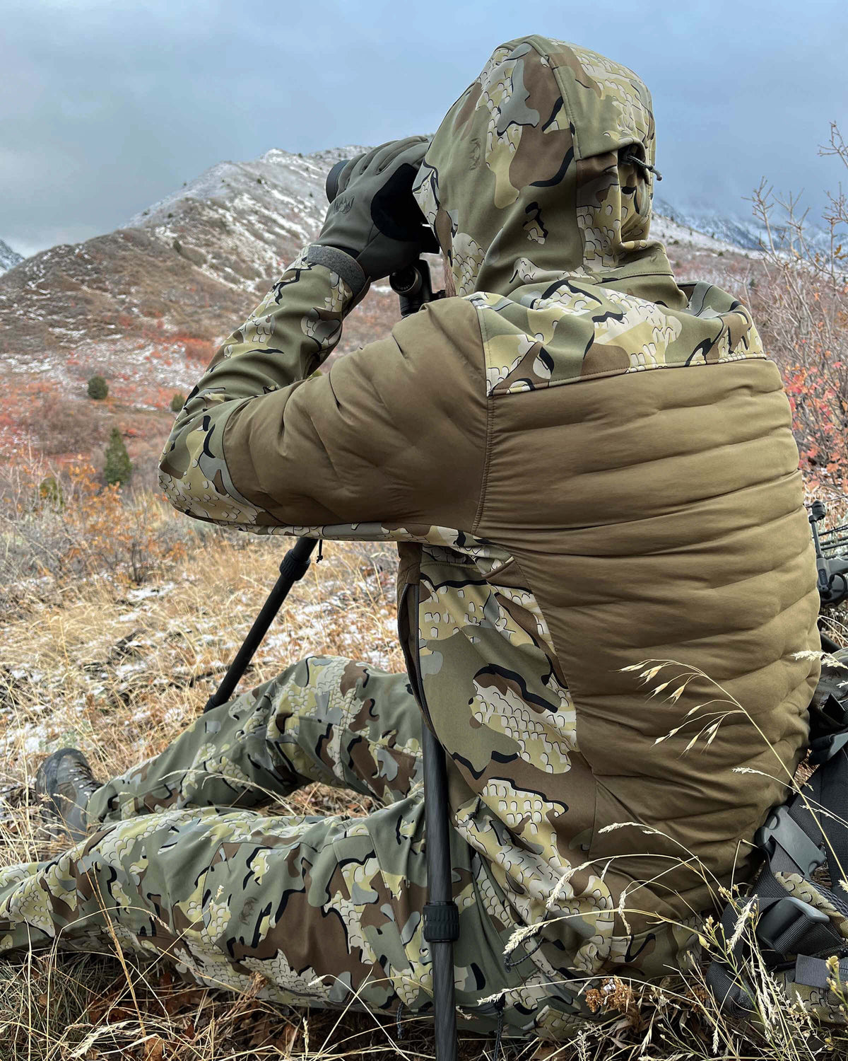 Rear, Angled View of Hunter Wearing Axis Thermal Hybrid Hooded Jacket in Valo Camouflage Highlighting Stitch-free Woven Baffles