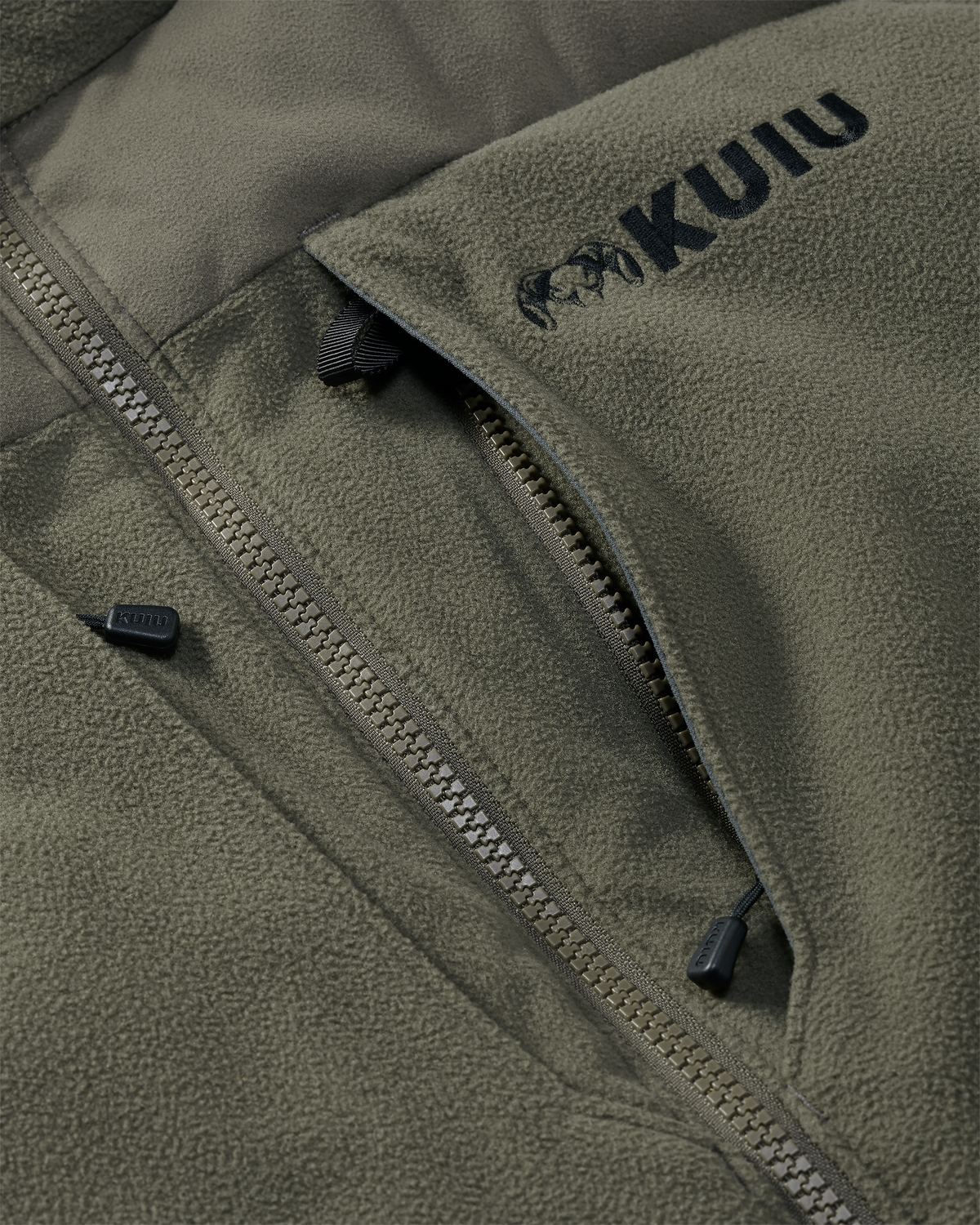 Close-up of vertical zippered chest pocket with inside accessory loop attachment on the Super Down Haven Hooded Jacket in Ash Brown