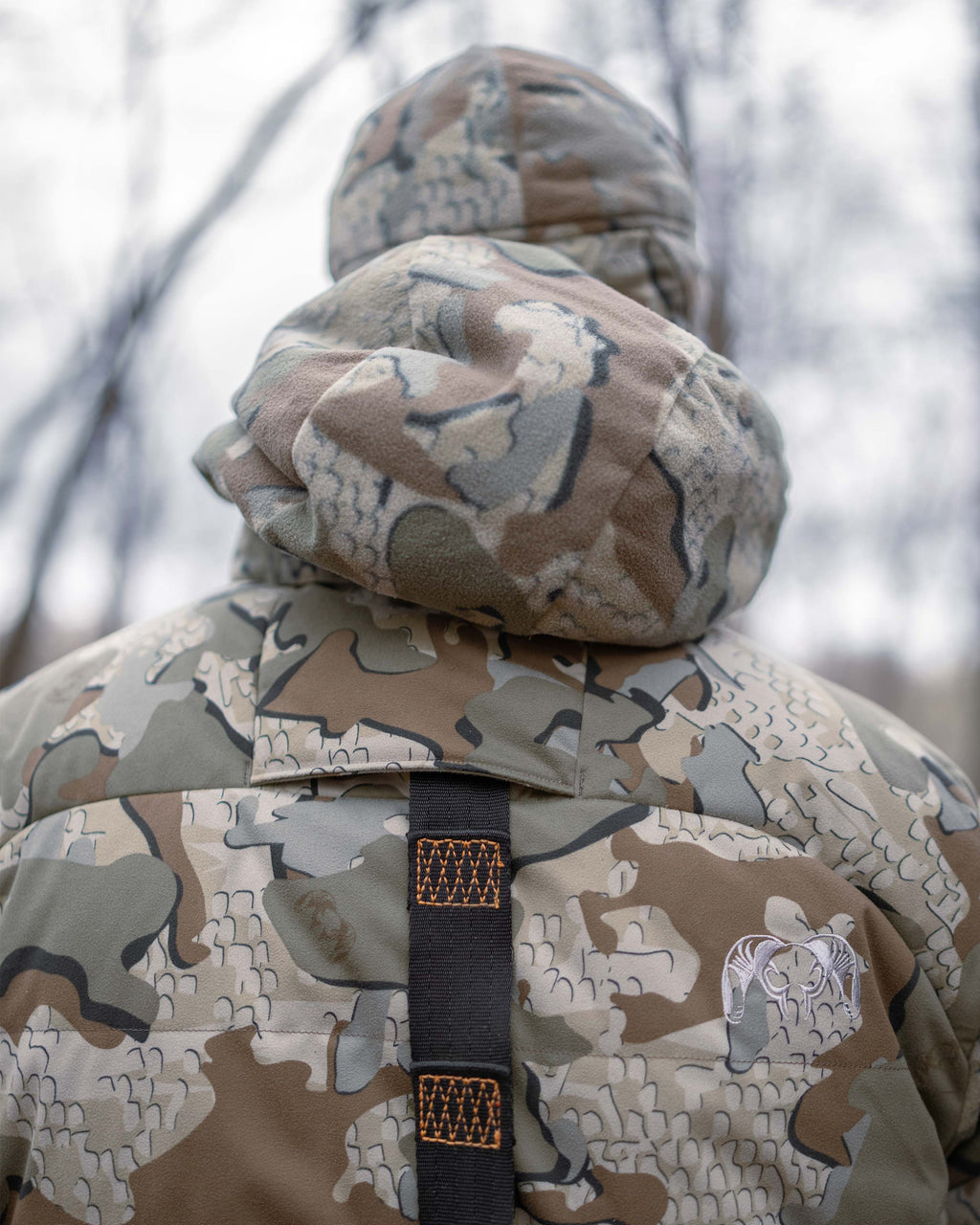 Back of Super Down Haven Hooded Jacket in Valo Camouflage, Highlighting safety harness port feature