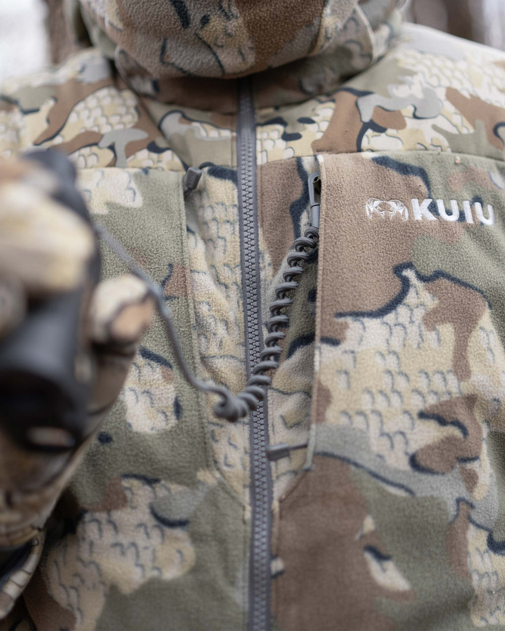 Close-up view of dual chest pocket featuring interior accessory loops on the Super Down Haven Hooded Jacket in Valo Camouflage