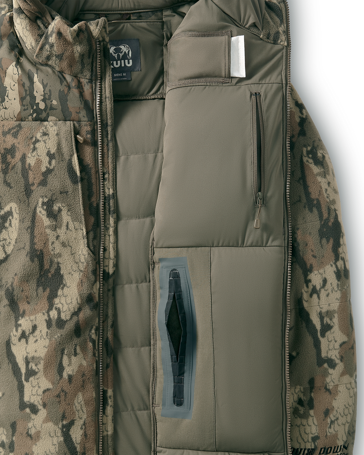 Close-up of a Super Down Haven Jacket in Veros Camouflage showing inner insulated front panel, zipper pocket, and a heat pack pocket.