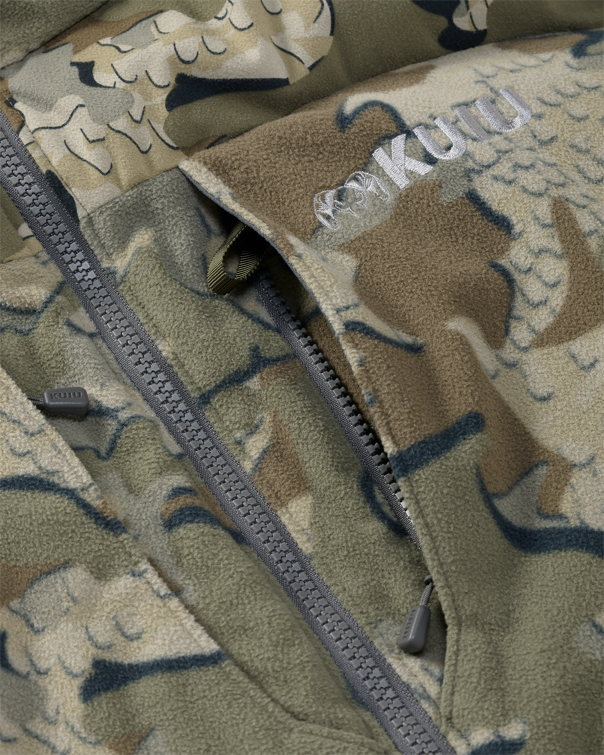 Close-up of vertical zippered chest pocket with inside accessory loop attachment on the Super Down Haven Hooded Jacket in Valo Camouflage