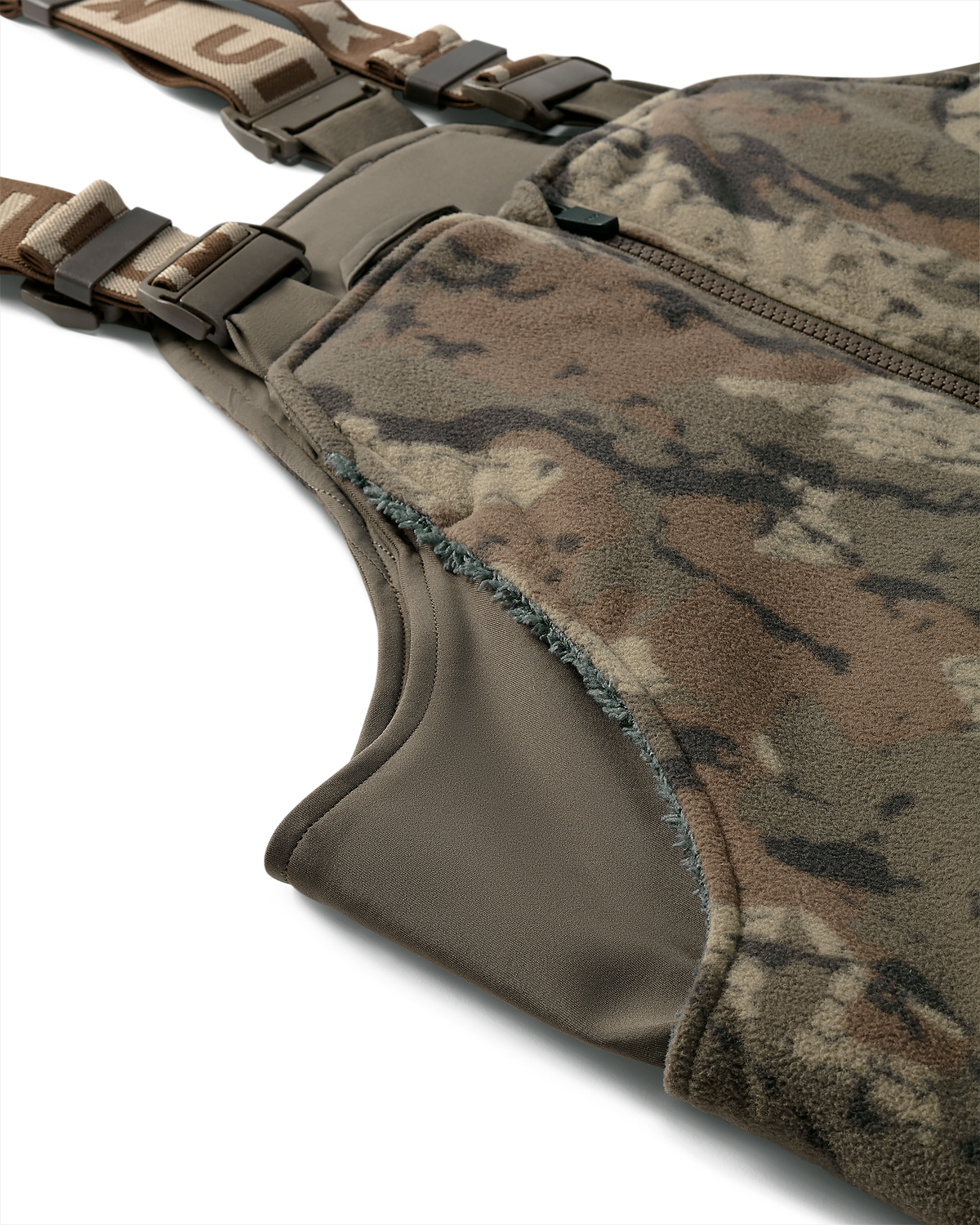 Close-up of side chest pocket of the Super Down Haven Bib in Veros camouflage with brown adjustable straps and buckles.
