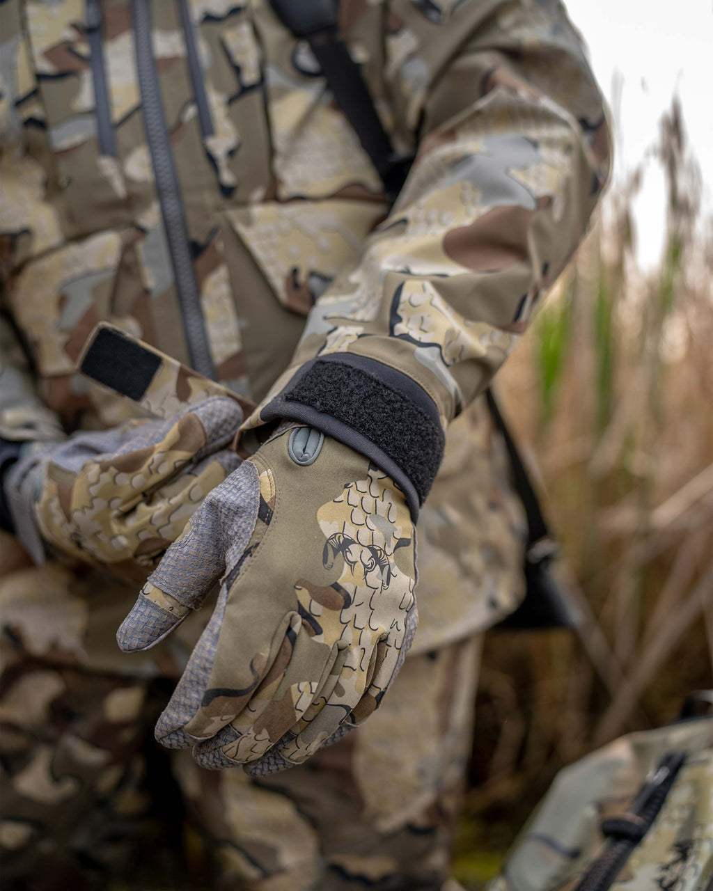 Detail waterfowl hunter tightening the neoprene cuff on the HD Flex Storm Shell Jacket in Valo Camouflage