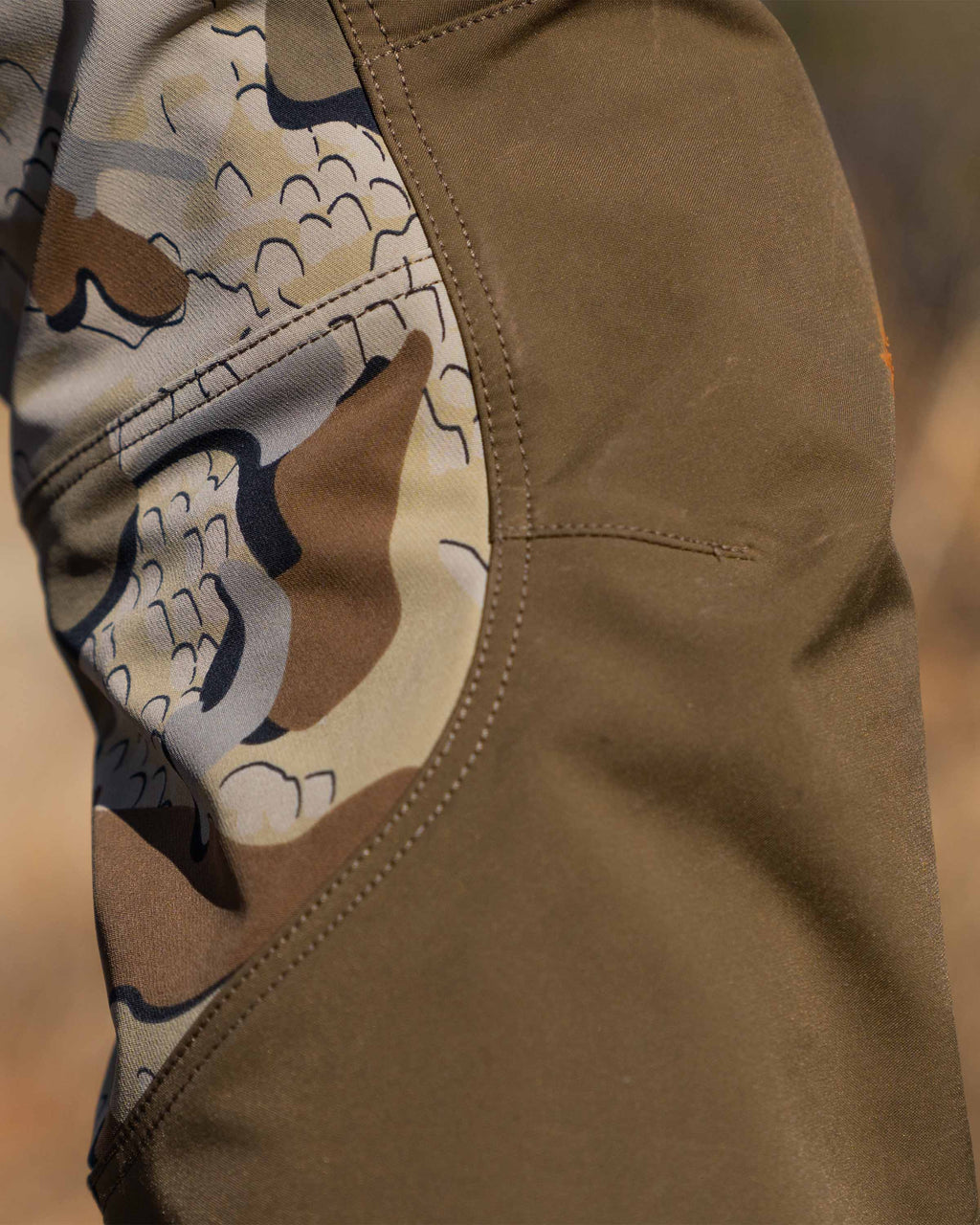 Detail of articulated knee and fabric of hunter in the field wearing PRO Brush Pant in Valo Camouflage