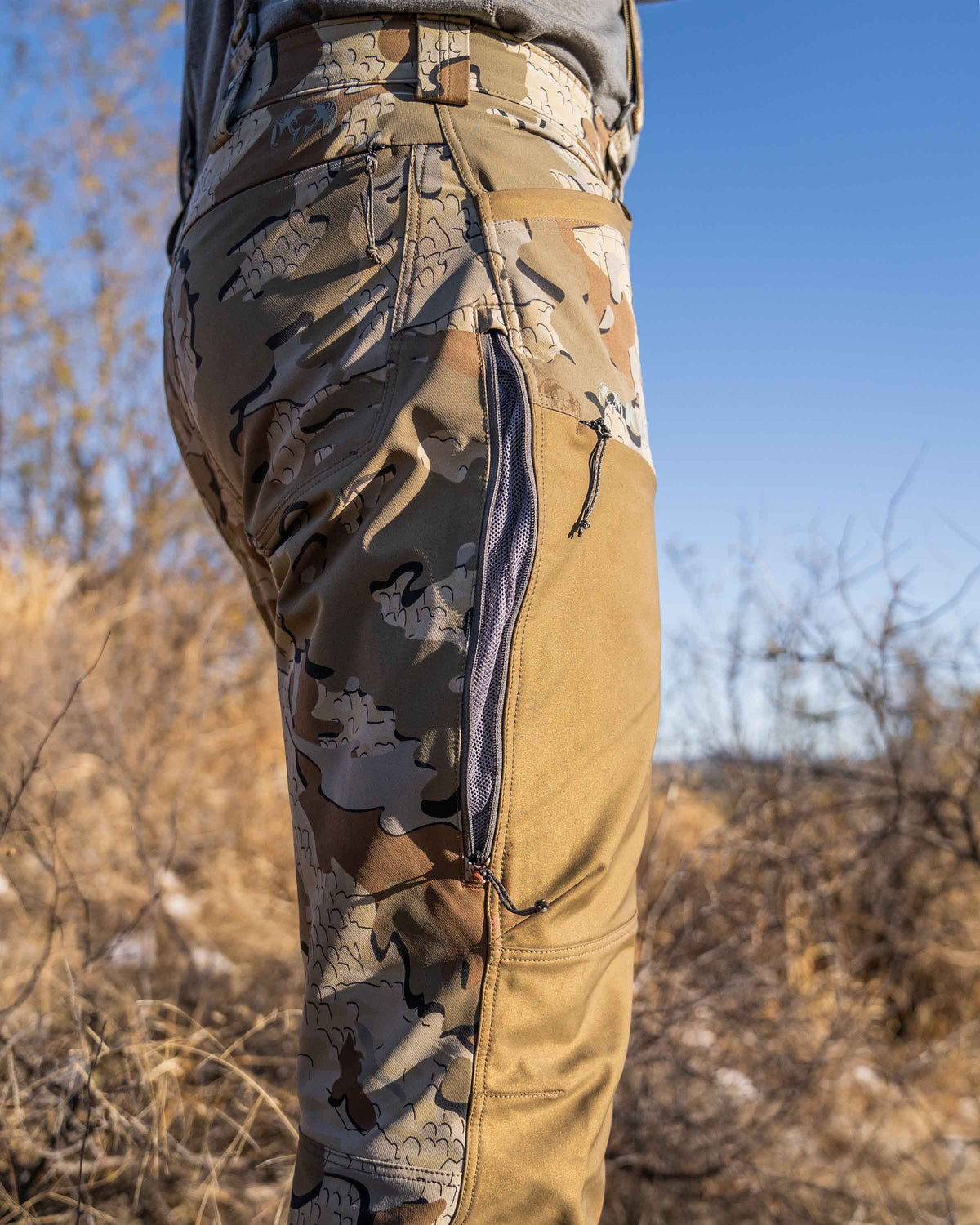 Detail outer hip vent on hunter in field wearing PRO Brush Pant in Valo Camouflage