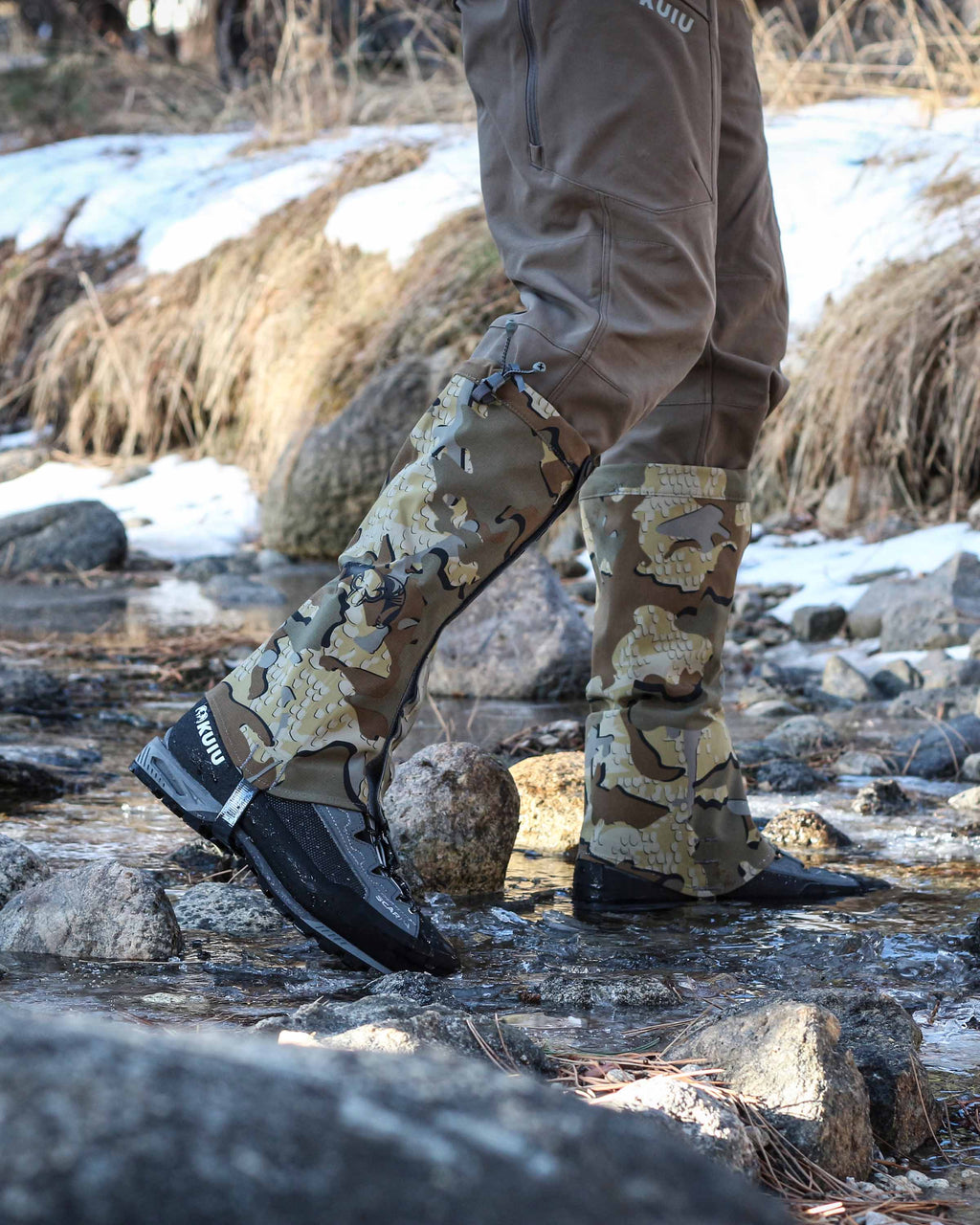 Side of Hunter Crossing Creek Wearing Kutana Storm Gaiters in Valo Camouflage