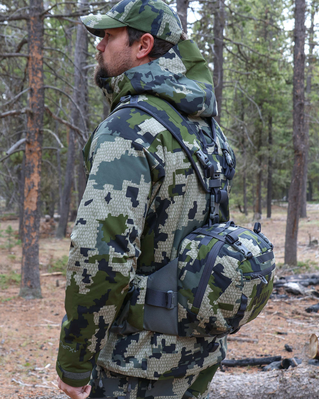 Side profile view of hunter wearing the Scout 1000 in Verde Camouflage, Highlighting integrated harness system and waist pack 