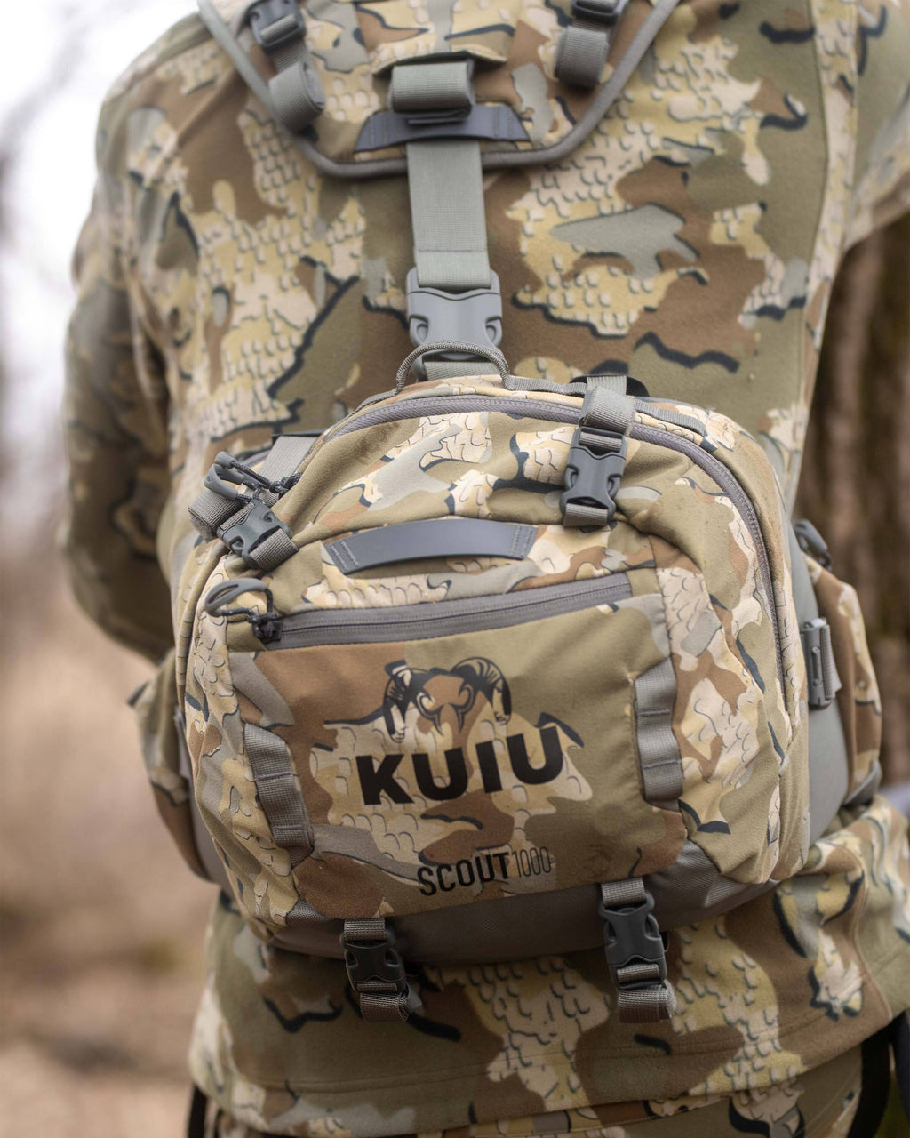 Close-up of Scout 1000 in Valo Camouflage, Highlighting external zippered pockets, top and bottom compression straps 