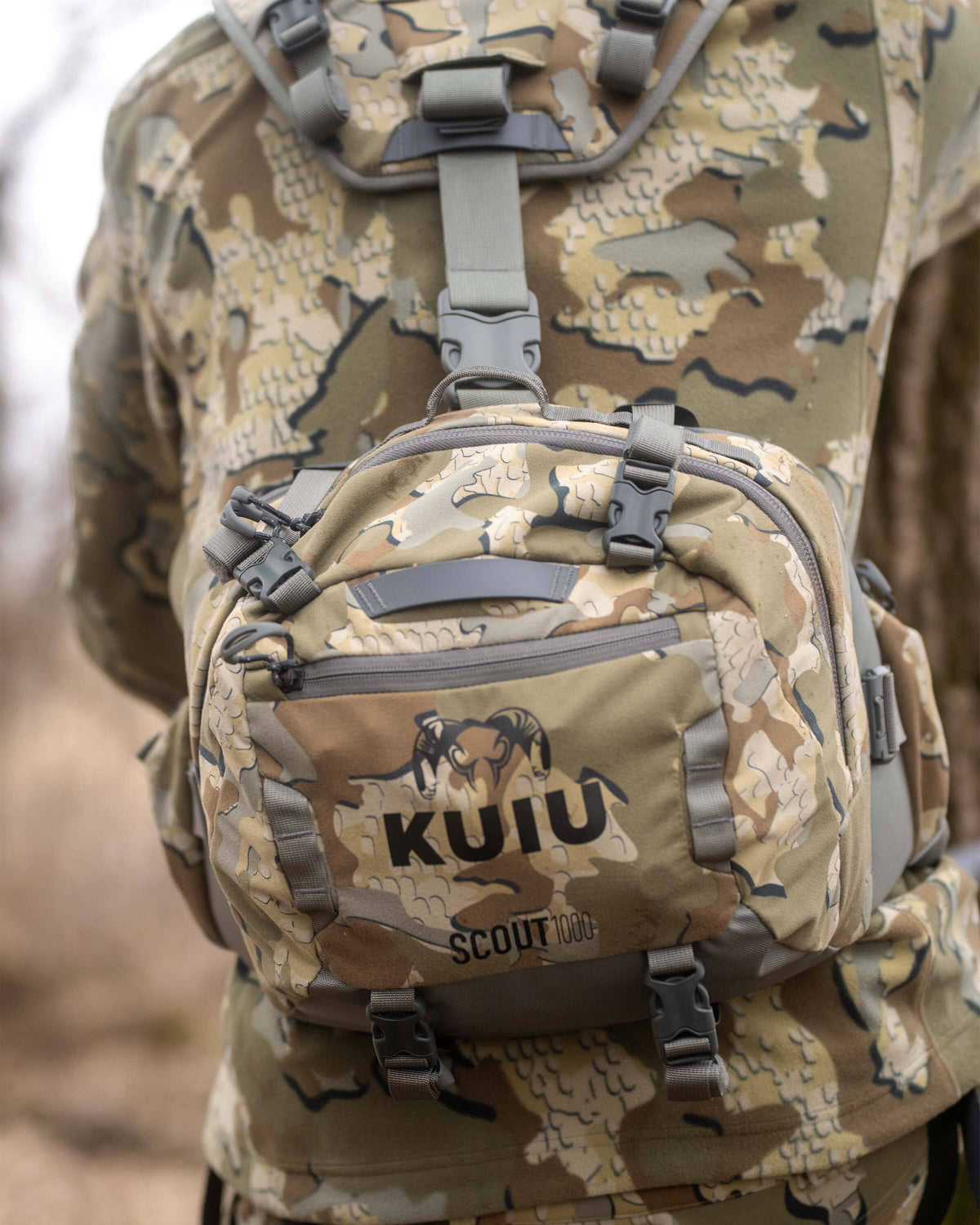 Close-up of Scout 1000 in Valo Camouflage, Highlighting external zippered pockets, top and bottom compression straps 
