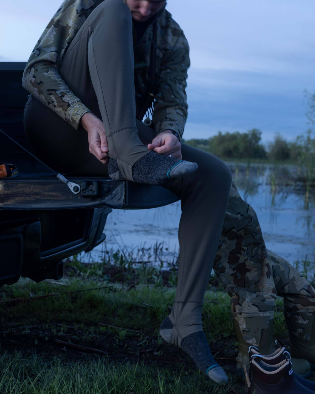 Hunter showing how to use stirrup cuffs on StrongFleece 290 Layering Pant in Ash brown