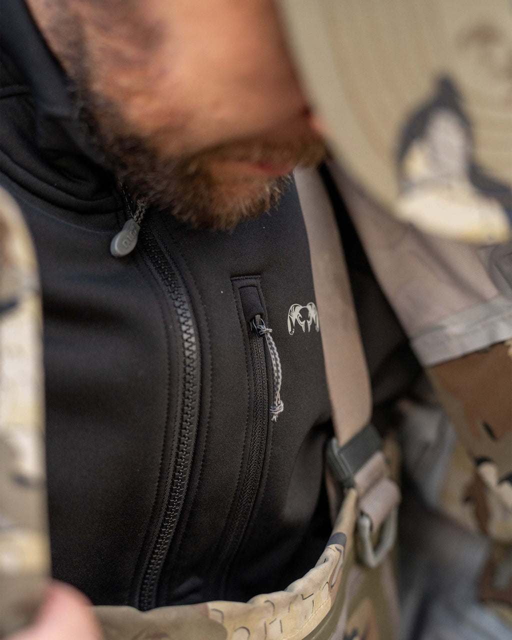 Hunter Wearing StrongFleece 290 WR Full Zip in Black highlighting YKK Zippered Chest Pocket