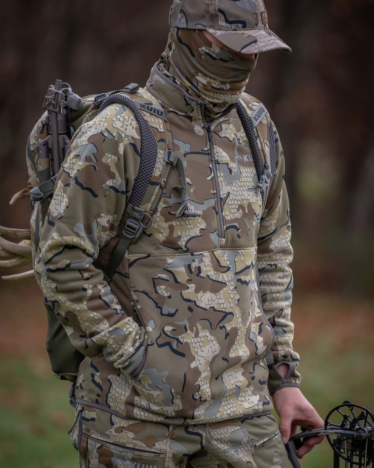 Angled view of Hunter wearing Encounter 290 Fleece Zip-T in Valo Camouflage