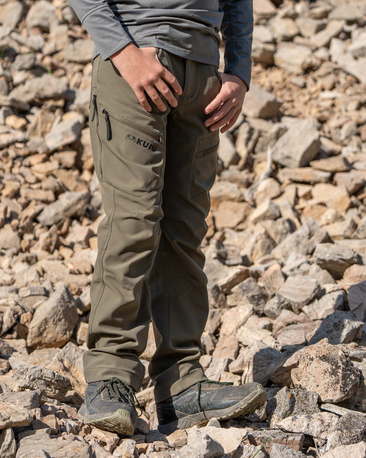 Youth wearing Youth Attack Pant in Ash Brown with thumbs in his pocket