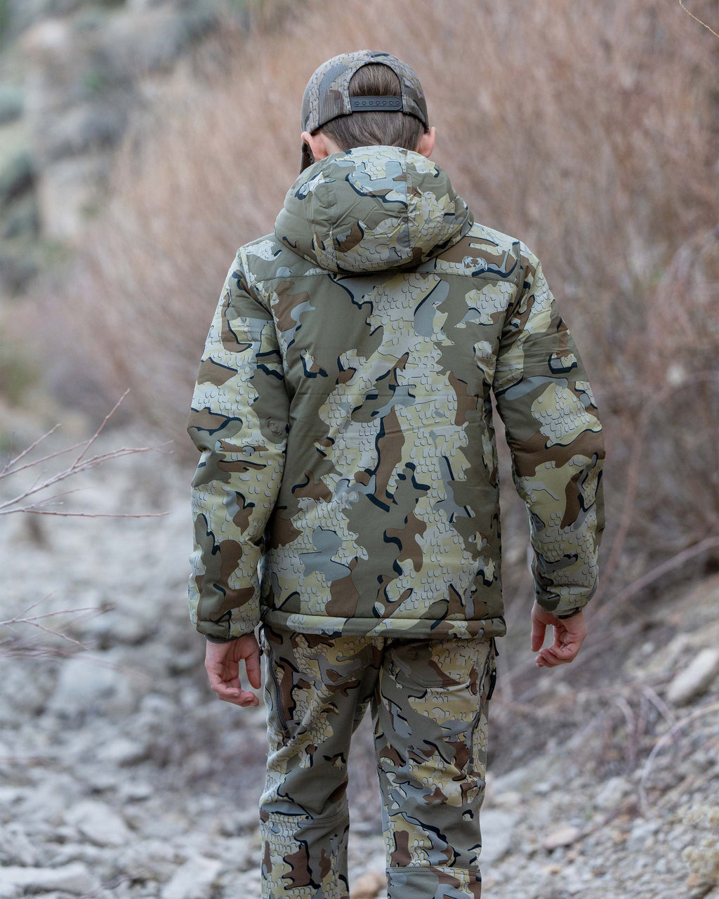 Back view of boy wearing Youth Reversible Versa Jacket in Valo Camouflage