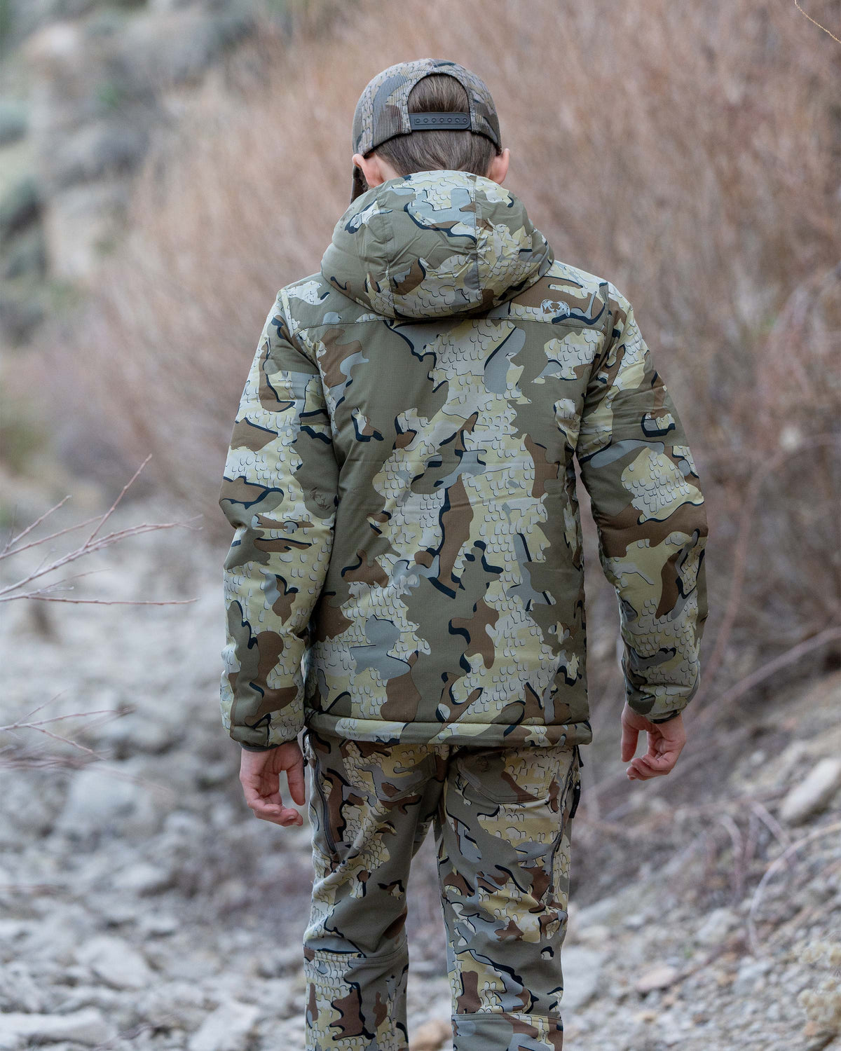 Back view of boy wearing Youth Reversible Versa Jacket in Valo Camouflage