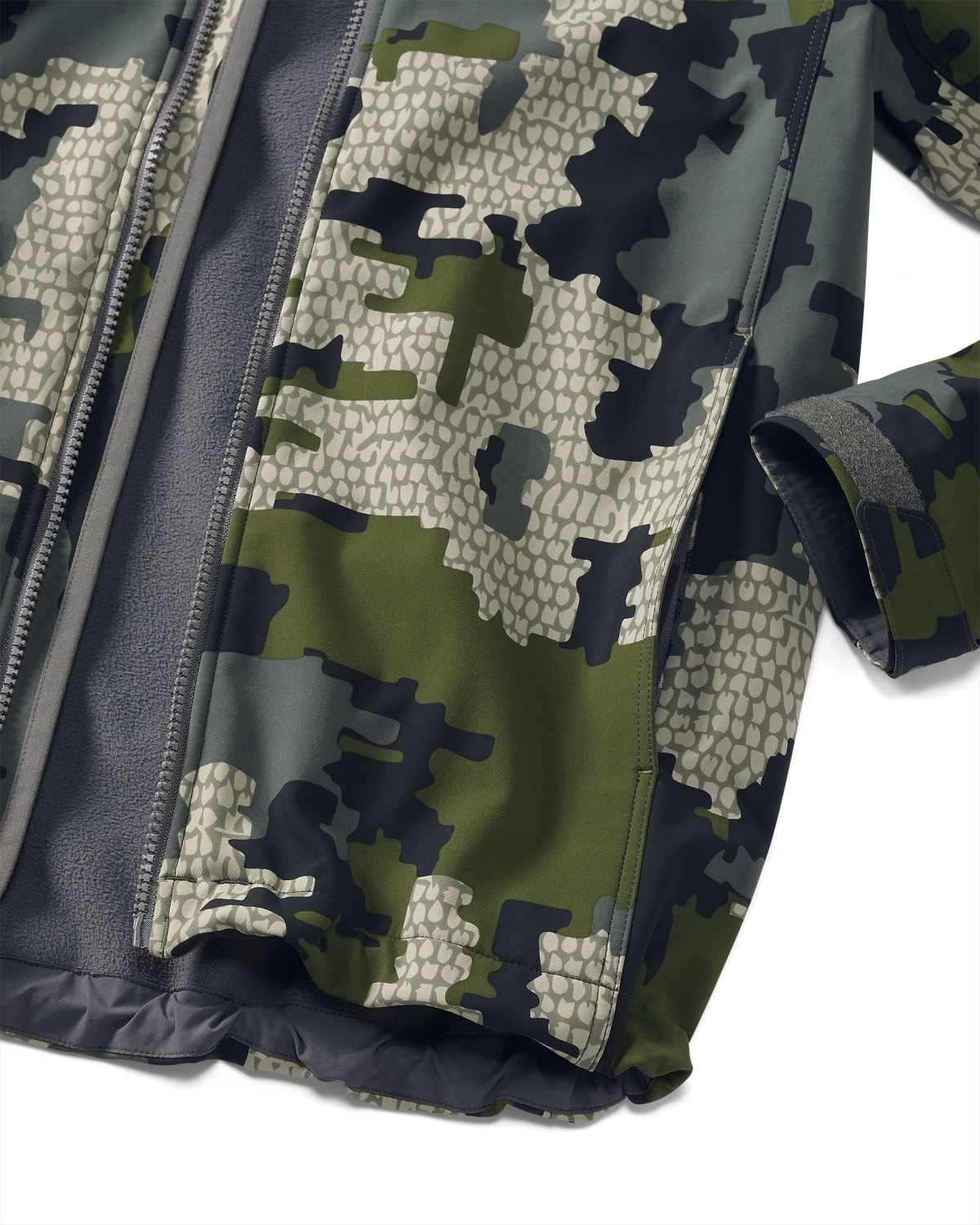 Detail showing hand pocket and adjustable velcro cuff on Youth Trail Blazer Jacket in Verde Camouflage