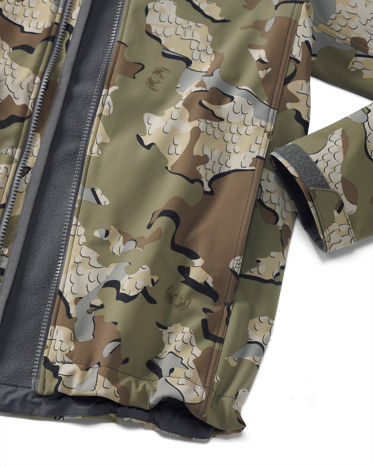 Detail showing hand pocket and adjustable velcro cuff on Youth Trail Blazer Jacket in Valo Camouflage