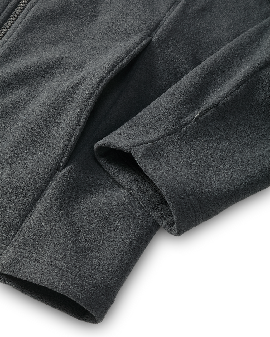 Close-up of the hand pocket and sewn utility loop on the bottom sleeve of a Youth Versa Fleece Full Zip in Gunmetal Grey.