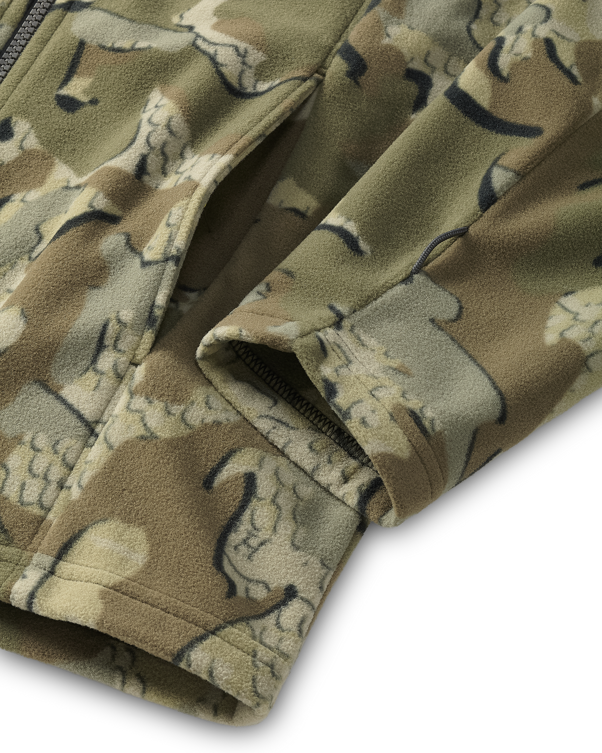 Close-up of the hand pocket and sewn utility loop on the bottom sleeve of a Youth Versa Fleece Full Zip in Valo Camouflage.