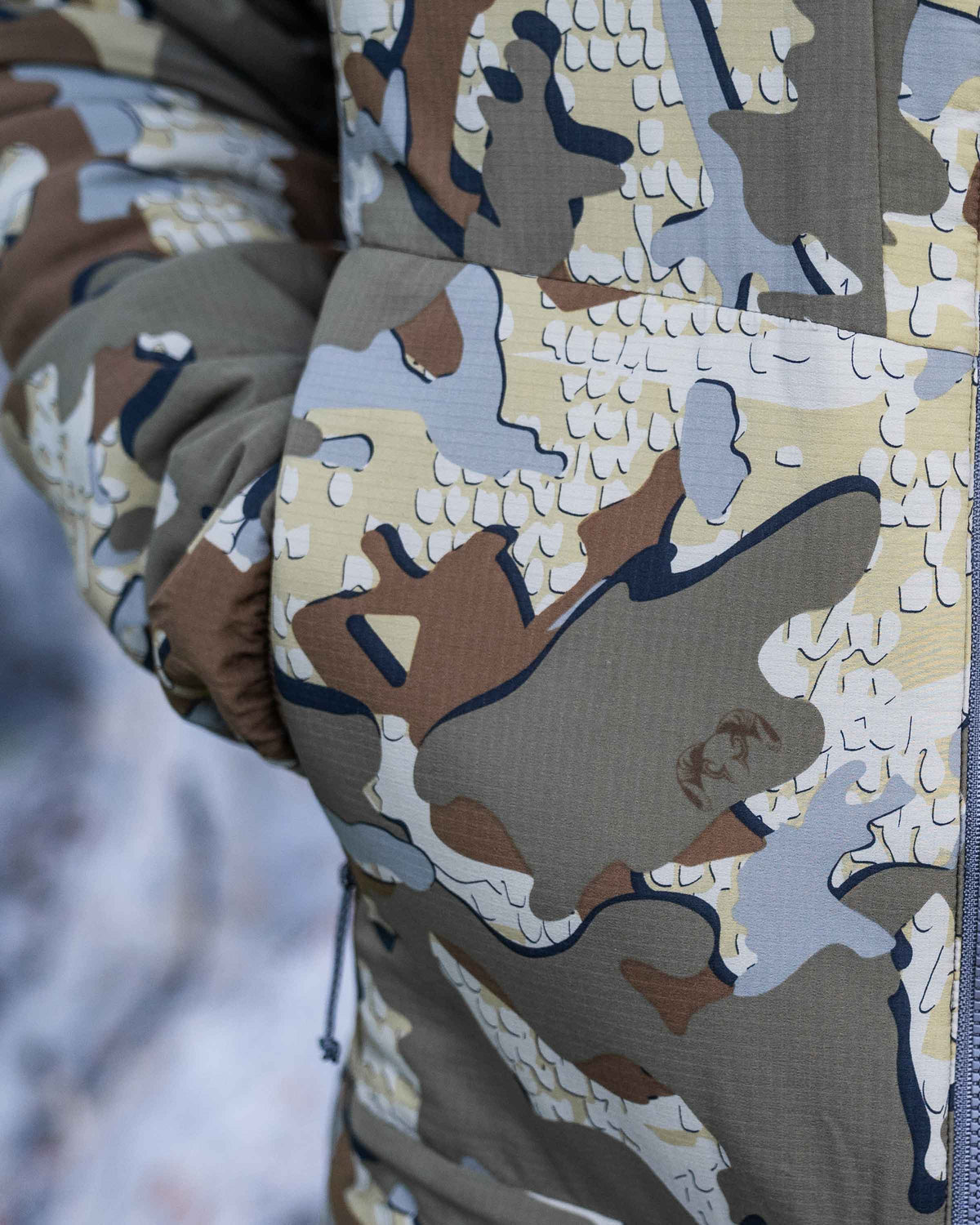 Zoomed in detail hand pocket on the Kenai Jacket in Valo Camouflage