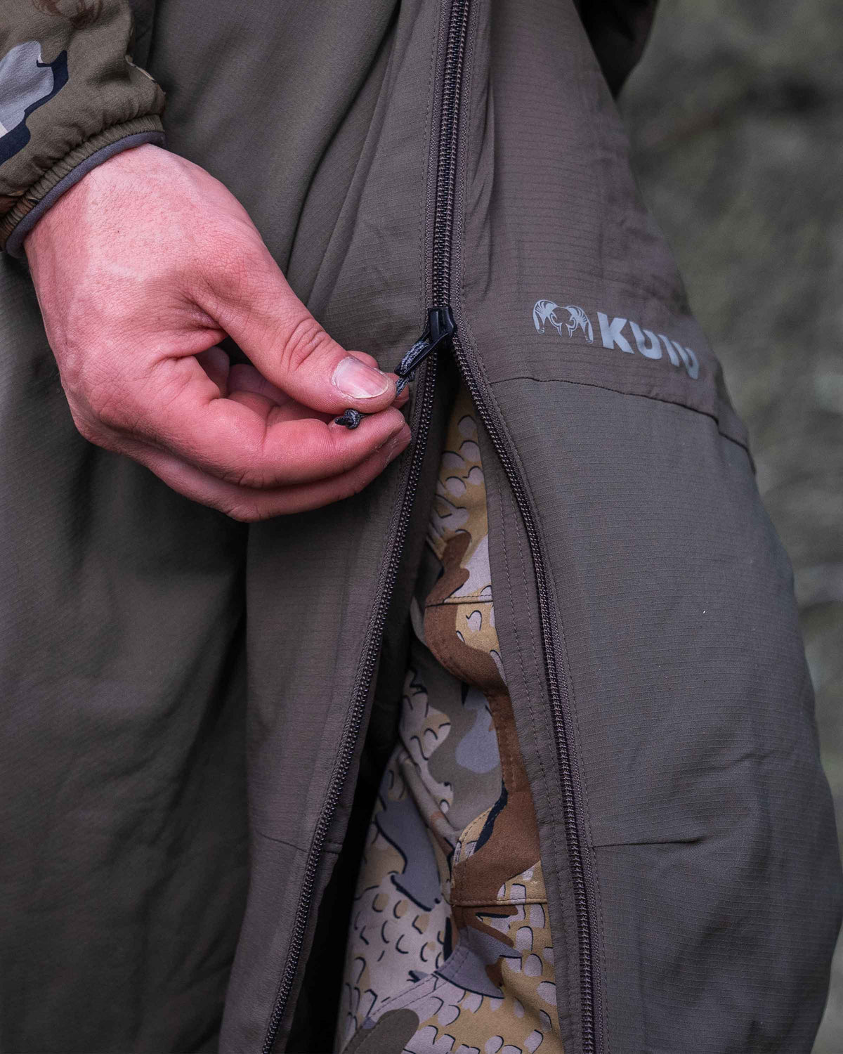 Detail of full length zipper on leg being used on Kenai Pant in Ash Brown