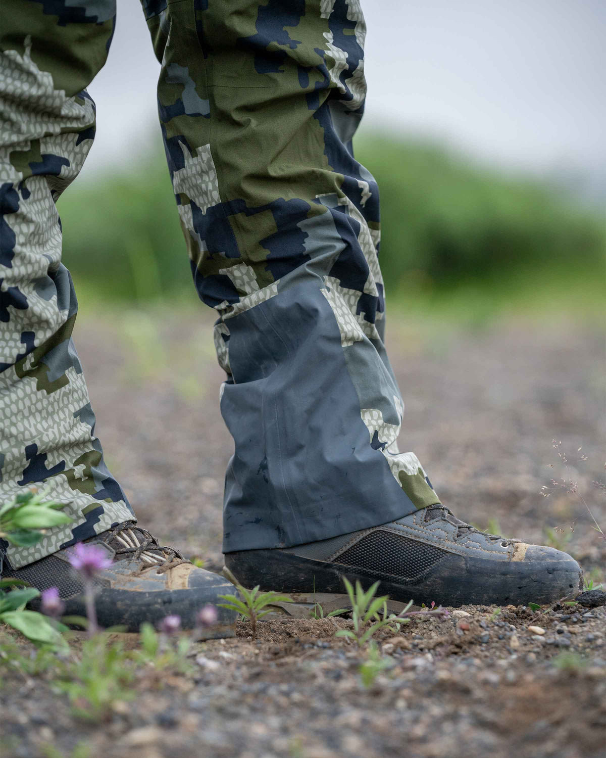 Hunter Wearing Chugach TR Rain Pant in Verde Camouflage Highlighting Bemis Overlay Film Scuff Guards