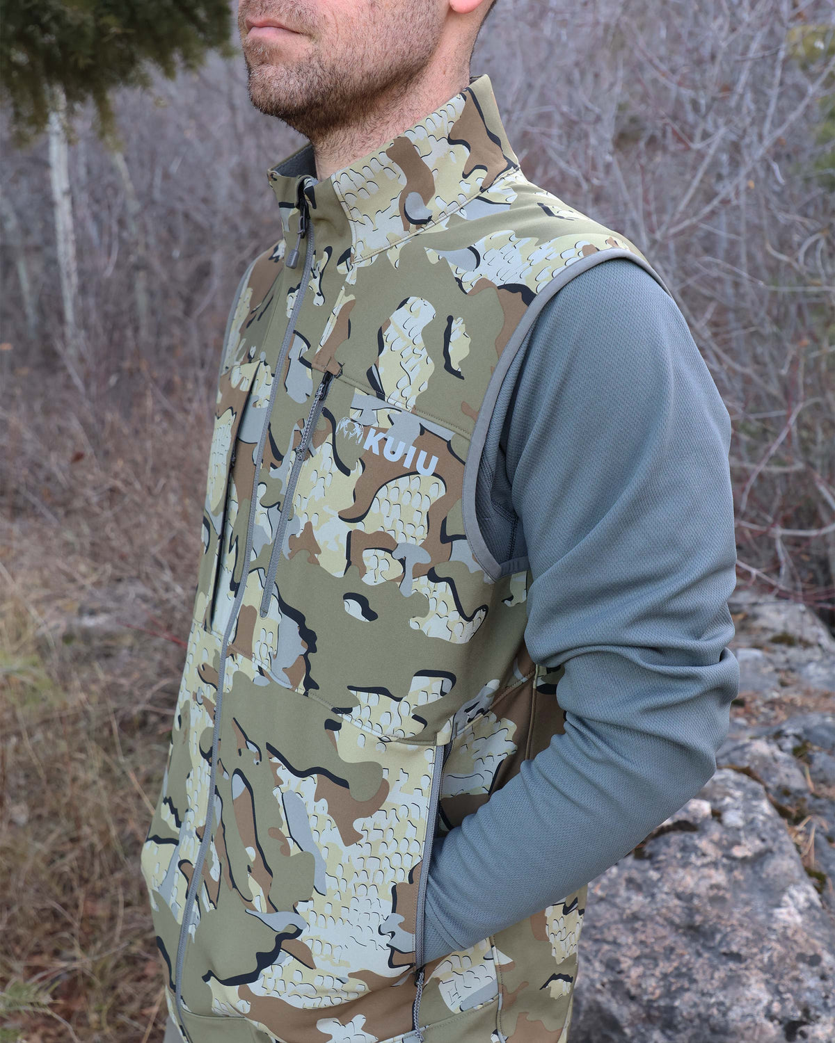 Left Guide PRO Vest in Valo Camouflage with hunter's hands in lower hand pockets