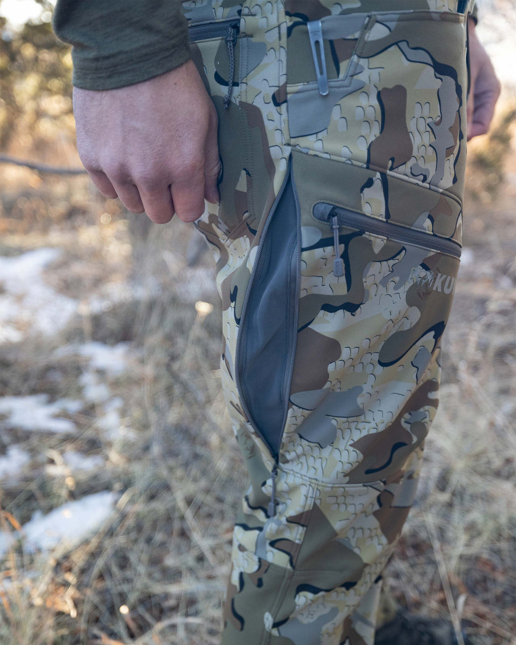 Guide PRO Pant in Valo with open hip vent showing knife in pocket to display reinforced fabric for knife clip