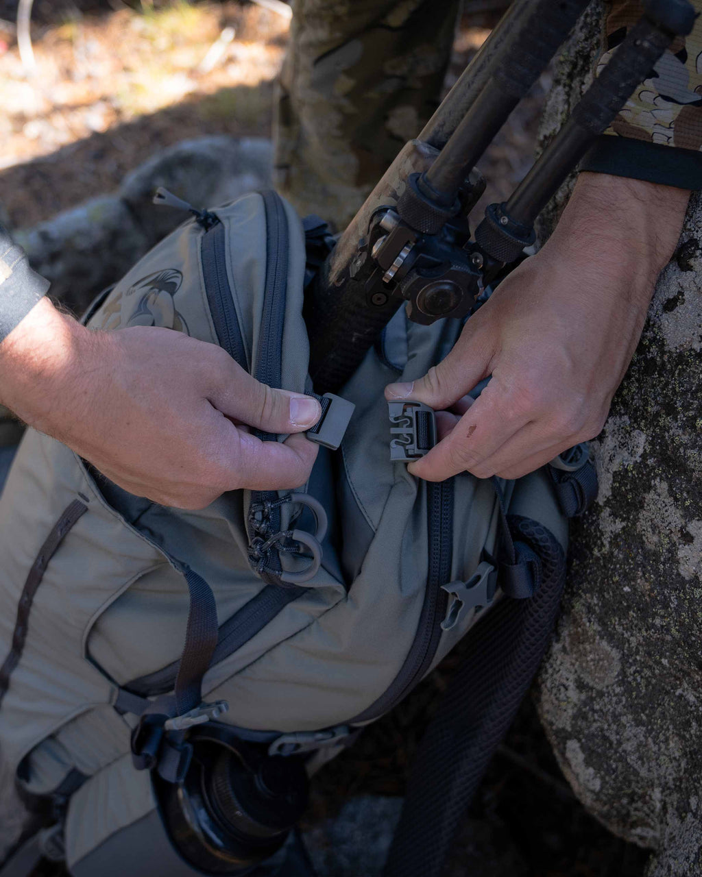 Hunter straping a rifle in the Divide pouch of the Venture Divide 2000 in Stone