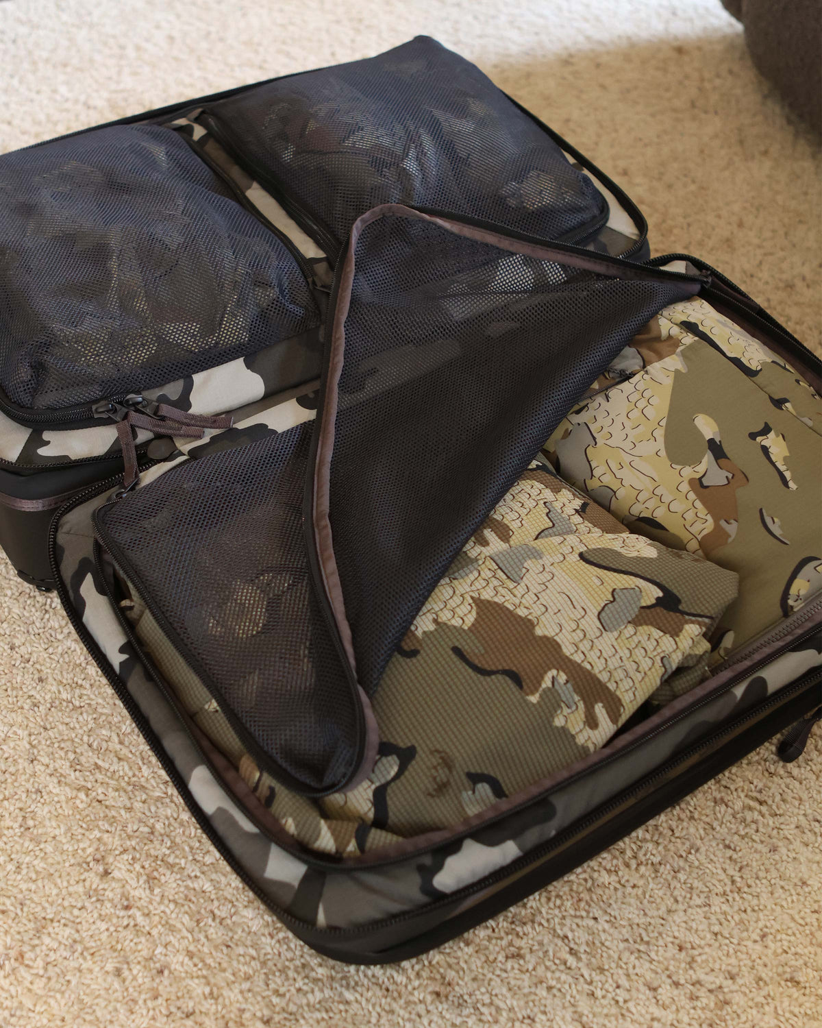 Opened view of Waypoint 3000 Roller Travel Bag, Highlighting internal main compartment with multiple internal storage, zippered mesh pockets for organization