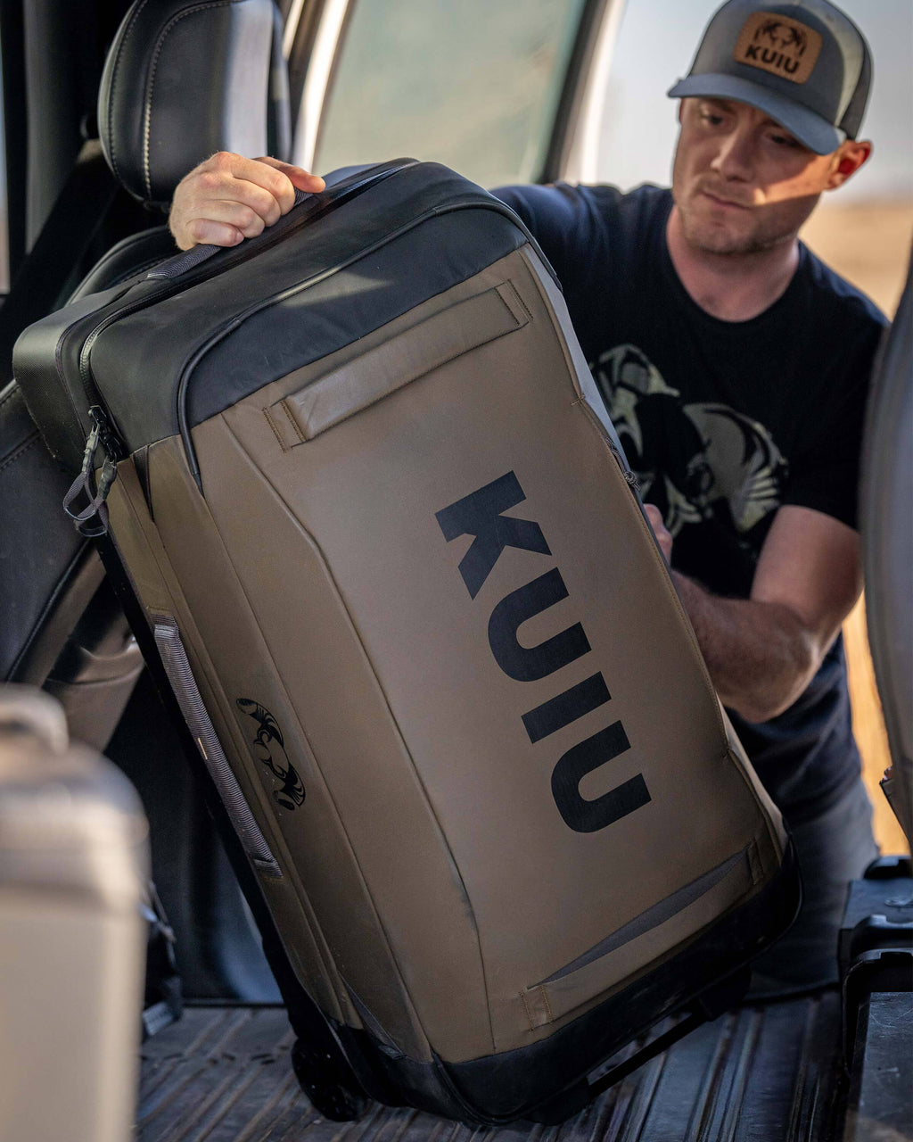 Man loading Waypoint 4500 Roller in Bourbon Brown in the back seat of a vehicle.