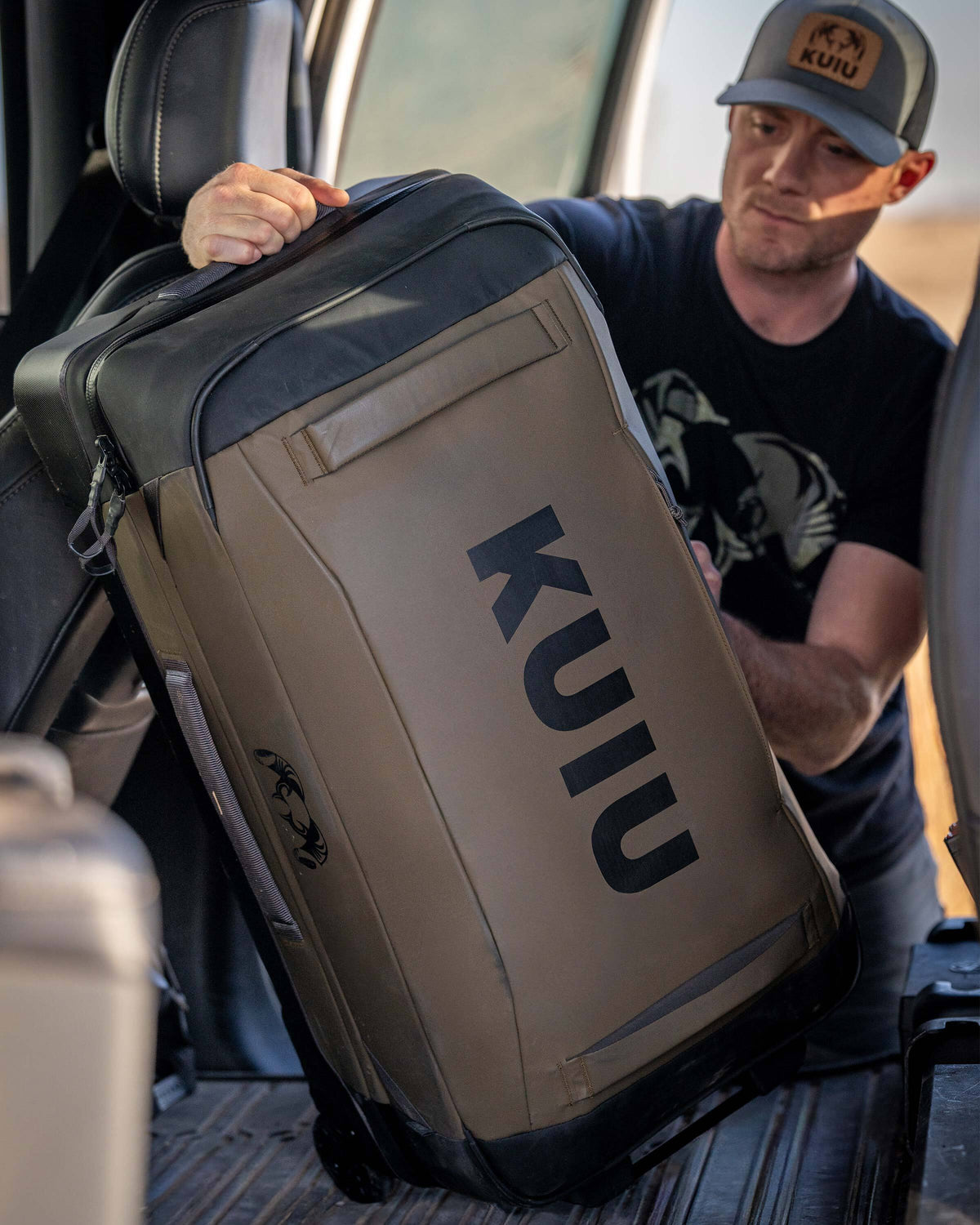 Man loading Waypoint 4500 Roller in Bourbon Brown in the back seat of a vehicle.