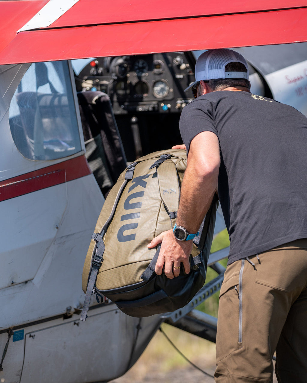 Picture of Bourbon Brown Waypoint 2800 Duffel Bag being loaded into a plane by a man