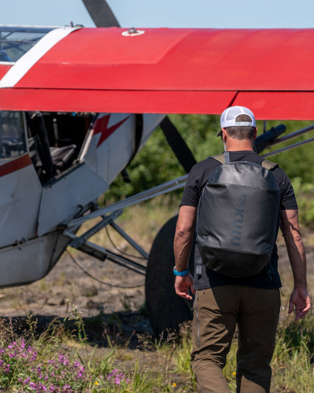 Picture of hunter wearing the Bourbon Brown Waypoint 2800 Duffel Bag as a backpack showing the black material used on the bottom of the bag