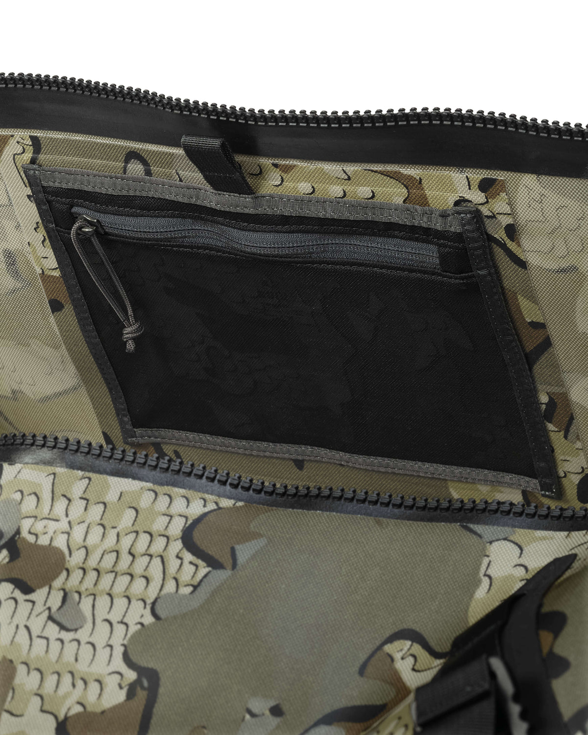 Side, Interior Profile of Kodiak 6600 Submersible Duffel in Valo Camouflage Highlighting Interal Zippered Mesh Storage Pocket Under Lid