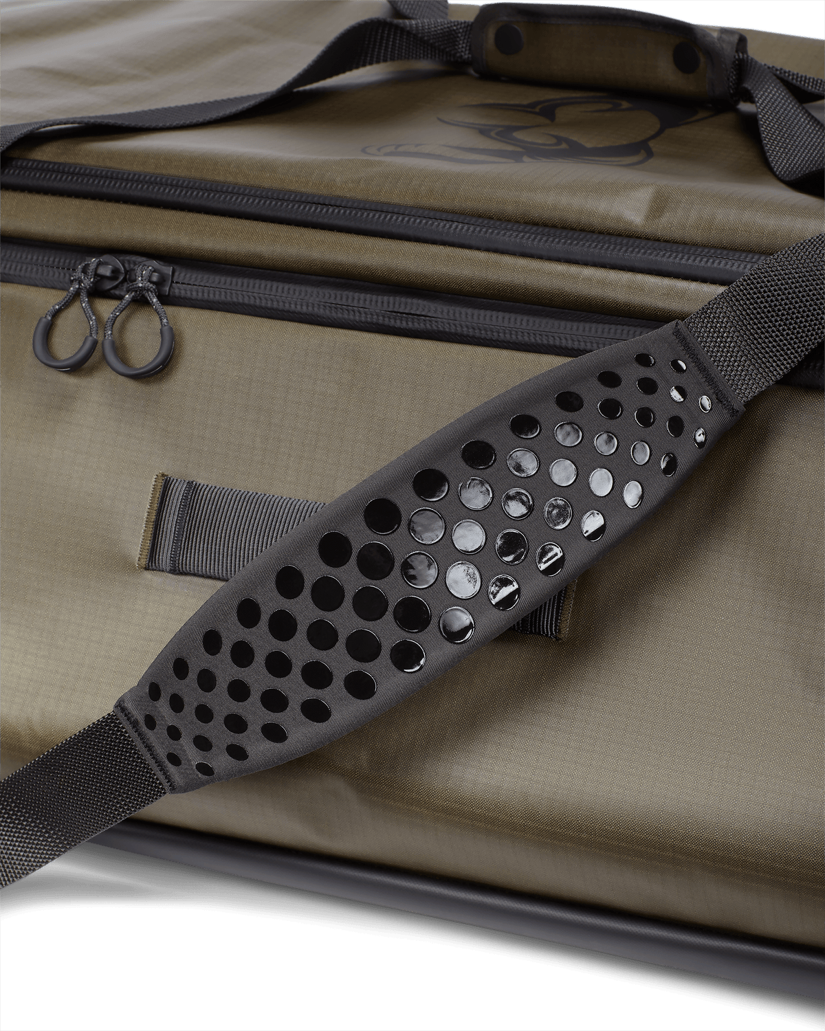 Close-up of non-slip, silicone dot matrix grip, padded shoulder strap on KUIU Two Track Duffel Bag in Bourbon Brown