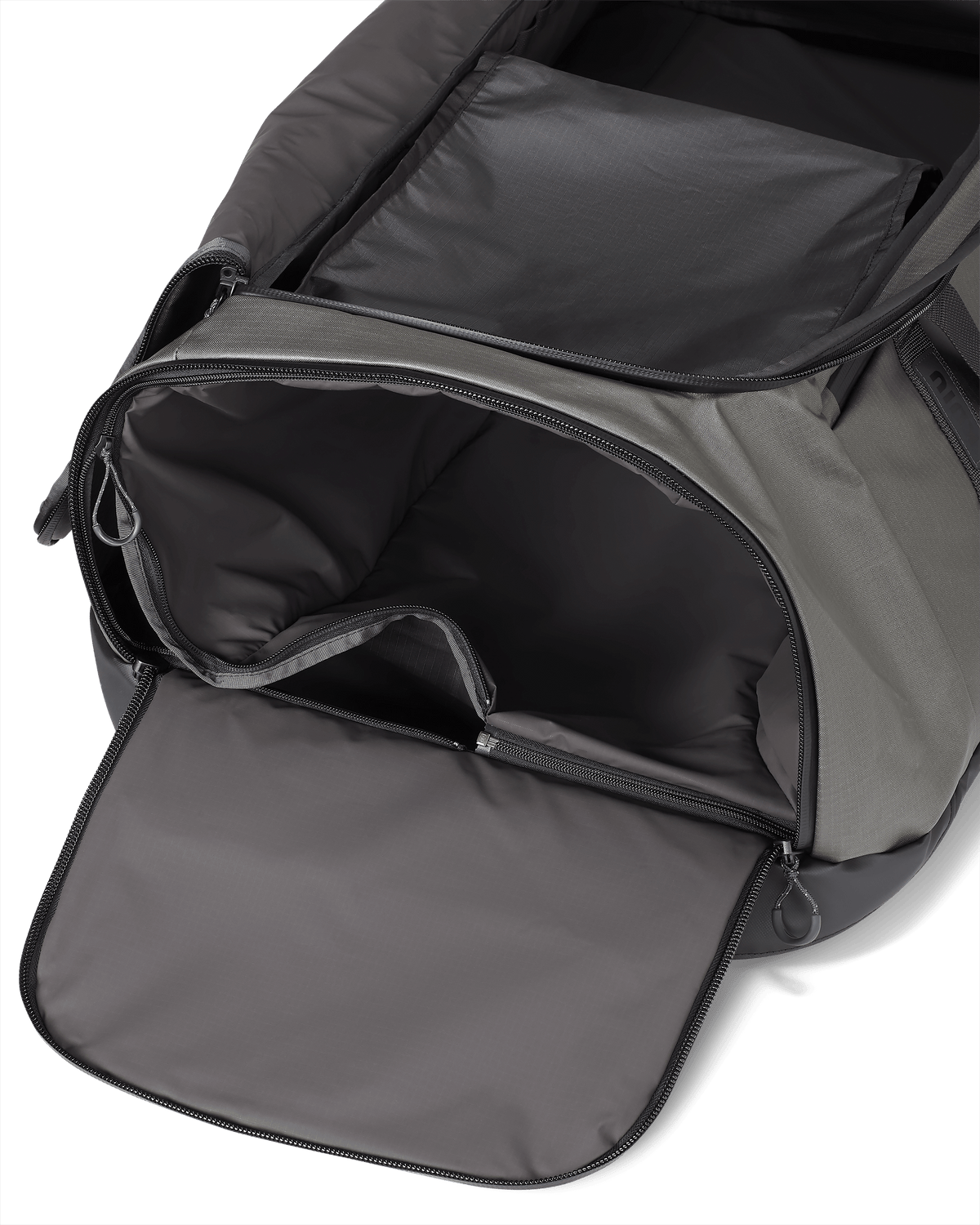 Zippered end pocket on the KUIU TwoTrack Duffel in Stone Grey, with waterproof and washable zip-out liner bag for wet gear storage