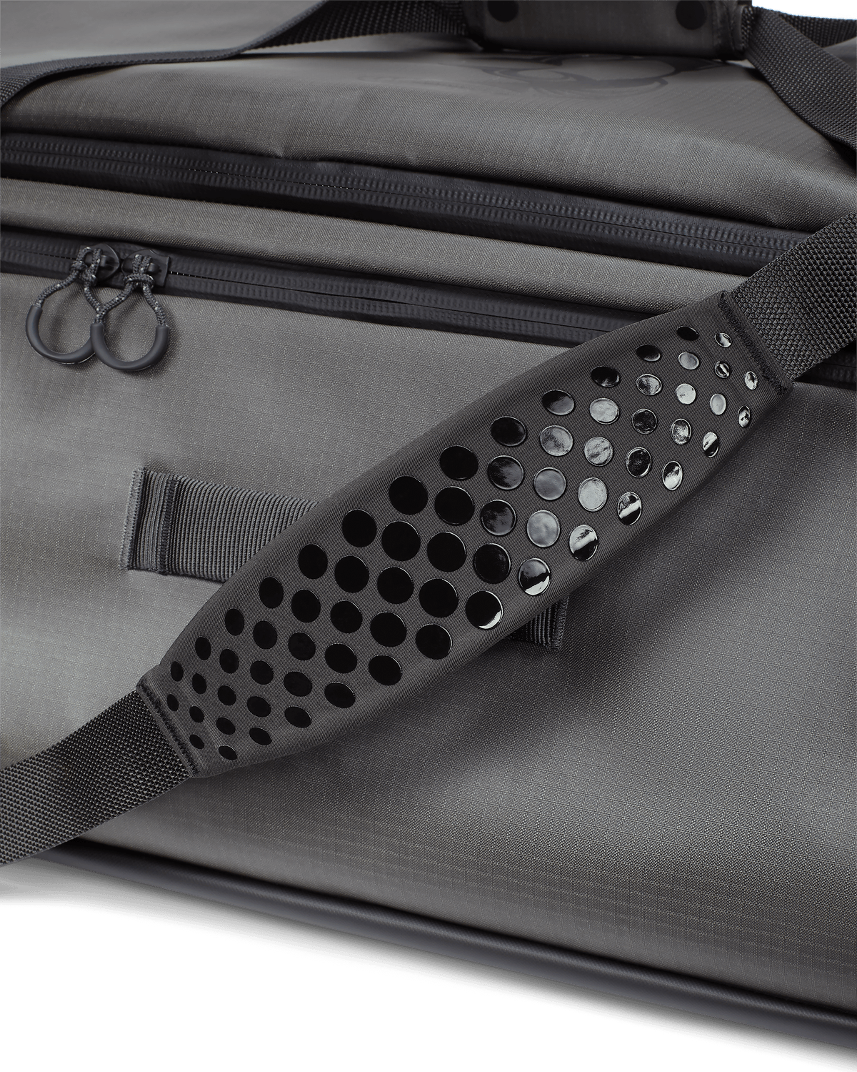 Close-up of non-slip, silicone dot matrix grip, padded shoulder strap on KUIU Two Track Duffel Bag in Stone Grey