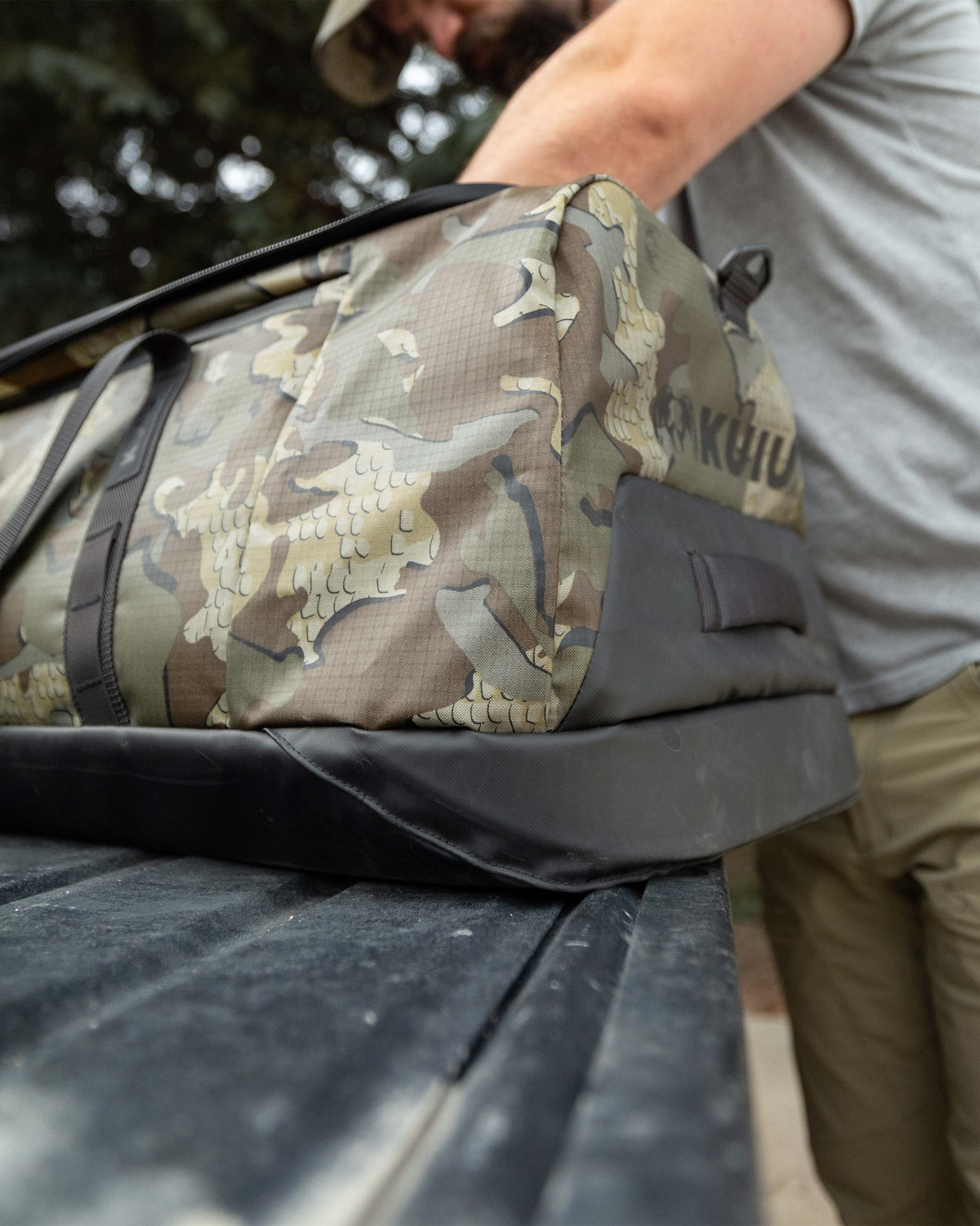 Close angled view of Hunter looking inside his TwoTrack 8000 Boot Duffel in Valo Camouflage