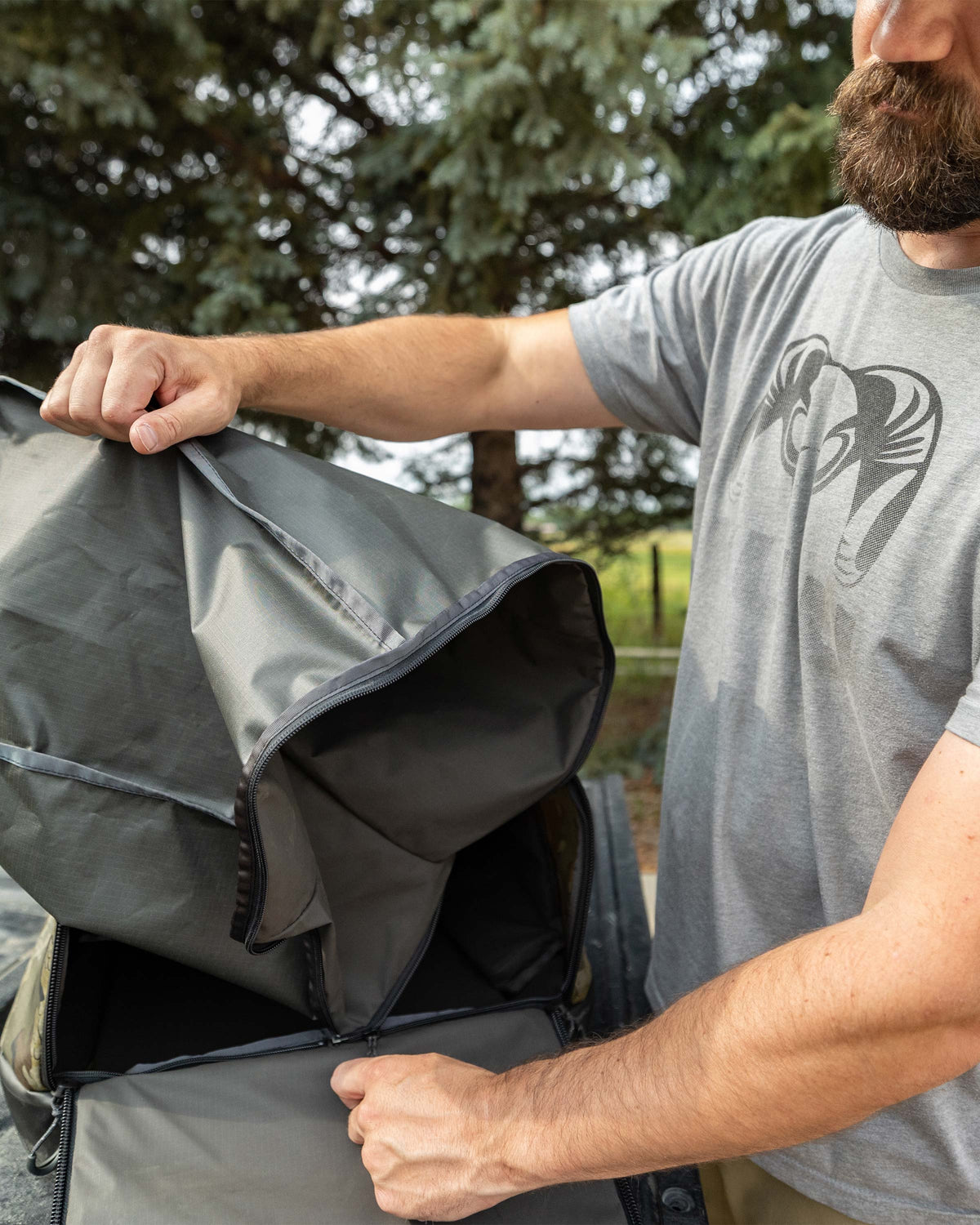 Hunter showing zip-out liner bag from the TwoTrack 8000 Boot Duffel in Valo Camouflage