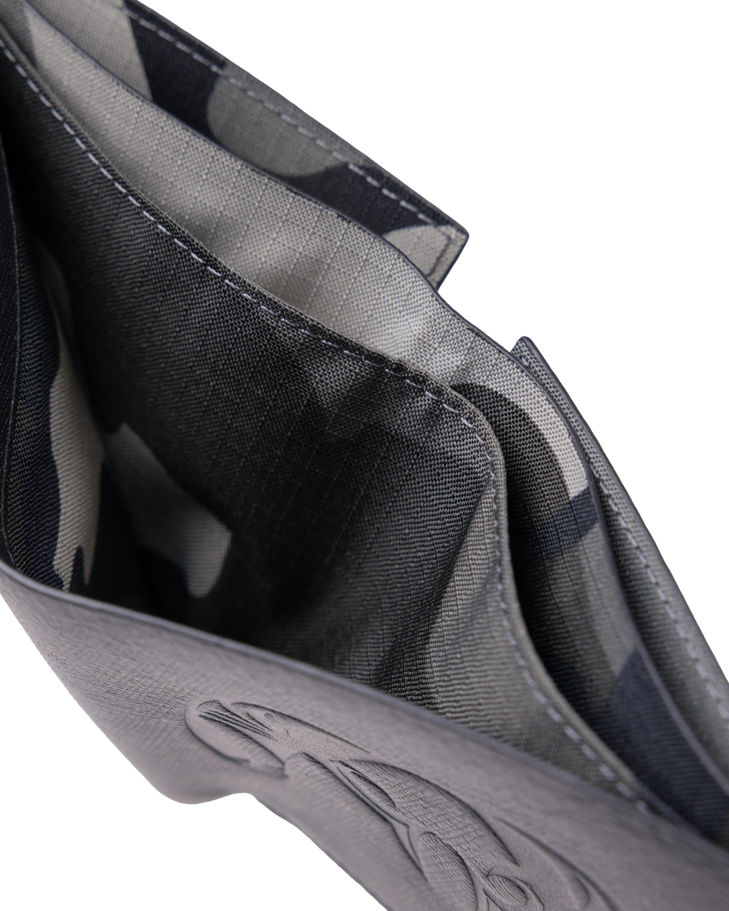 KUIU Leather wallet featuring a close-up of its interior Vias Storm camouflage lining, showing stitched compartments and a textured exterior with an embossed KUIU ram logo.