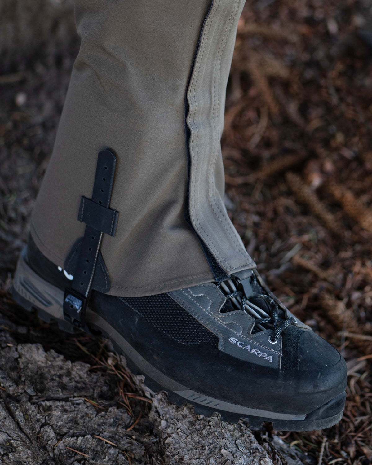 Angled view of Yukon HD Hunting Boot Gaiter in Ash Brown on hunter in field hiking