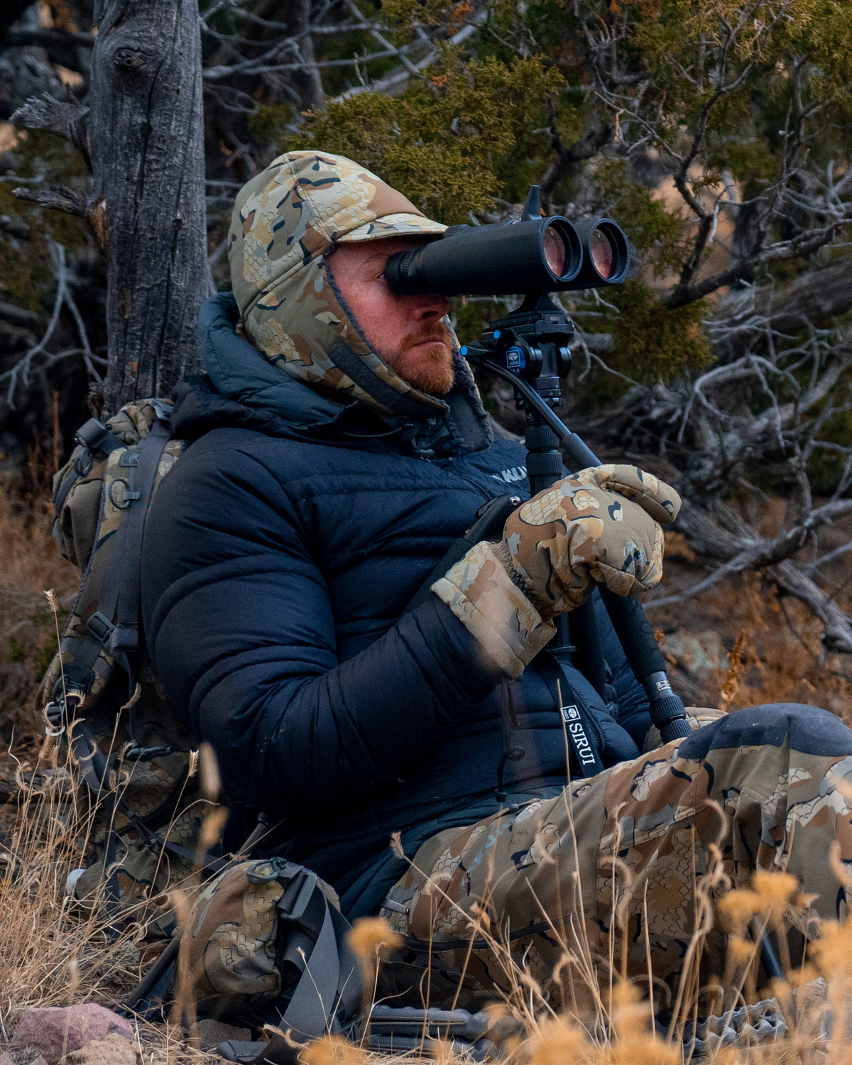 Front, Angled View of Hunter Glassing Game Wearing Kenai Hat in Valo Camouflage